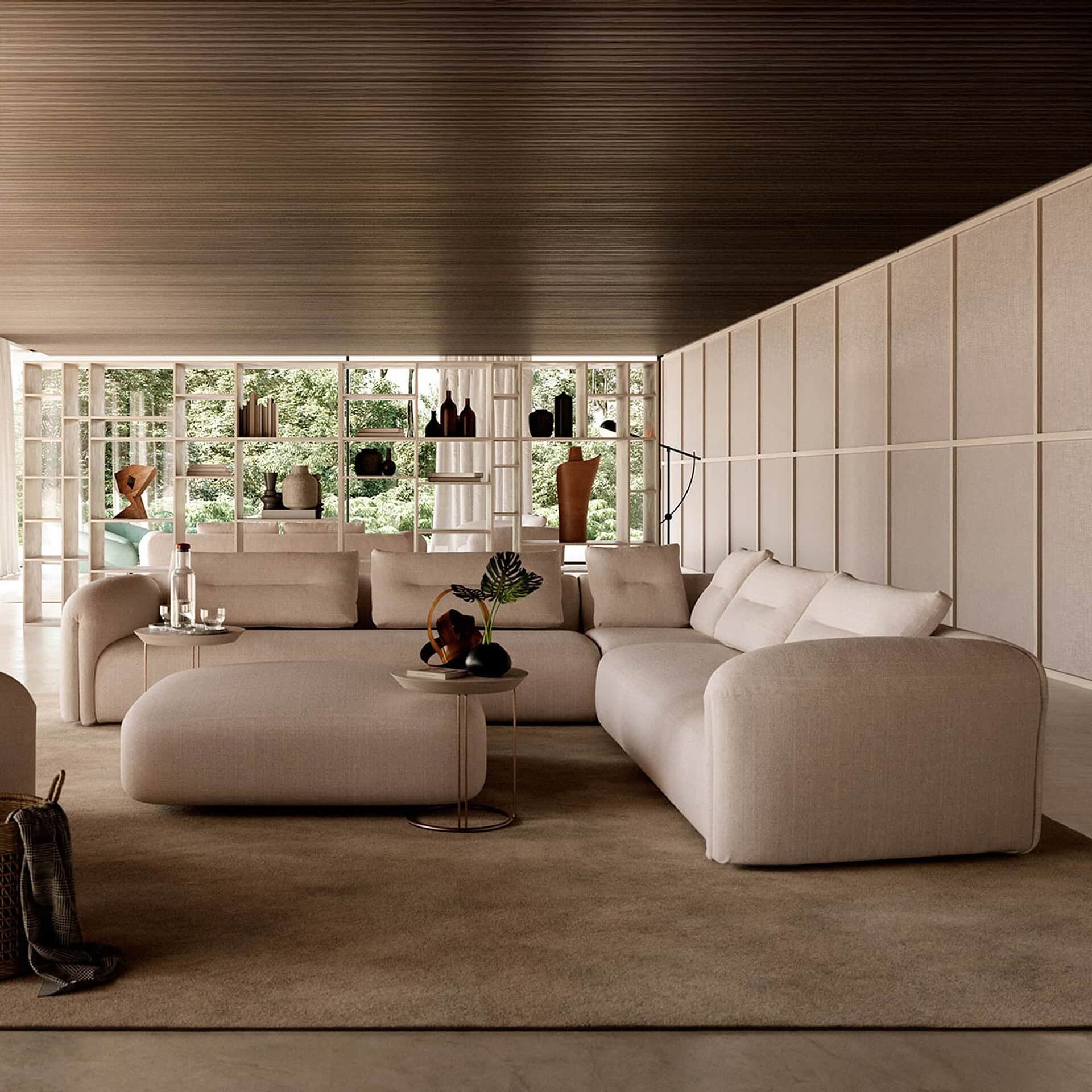 Quentin Angular Modular Sectional Sofa in cream fabric styled in an open-concept interior with bookshelves.