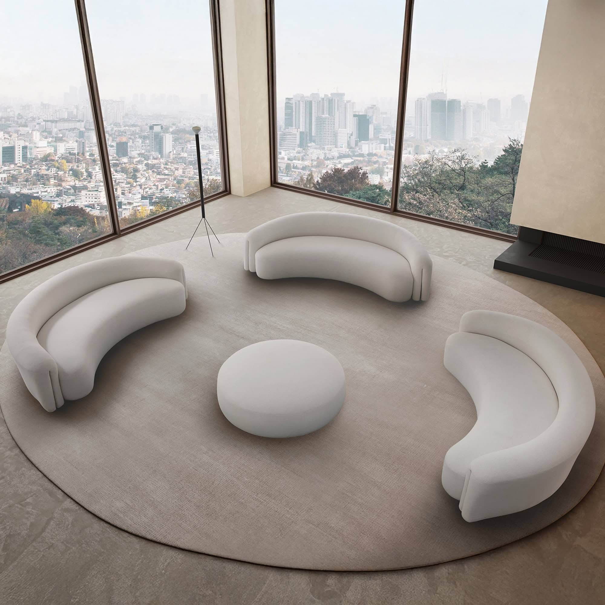 a room with a round white couch and a round white table