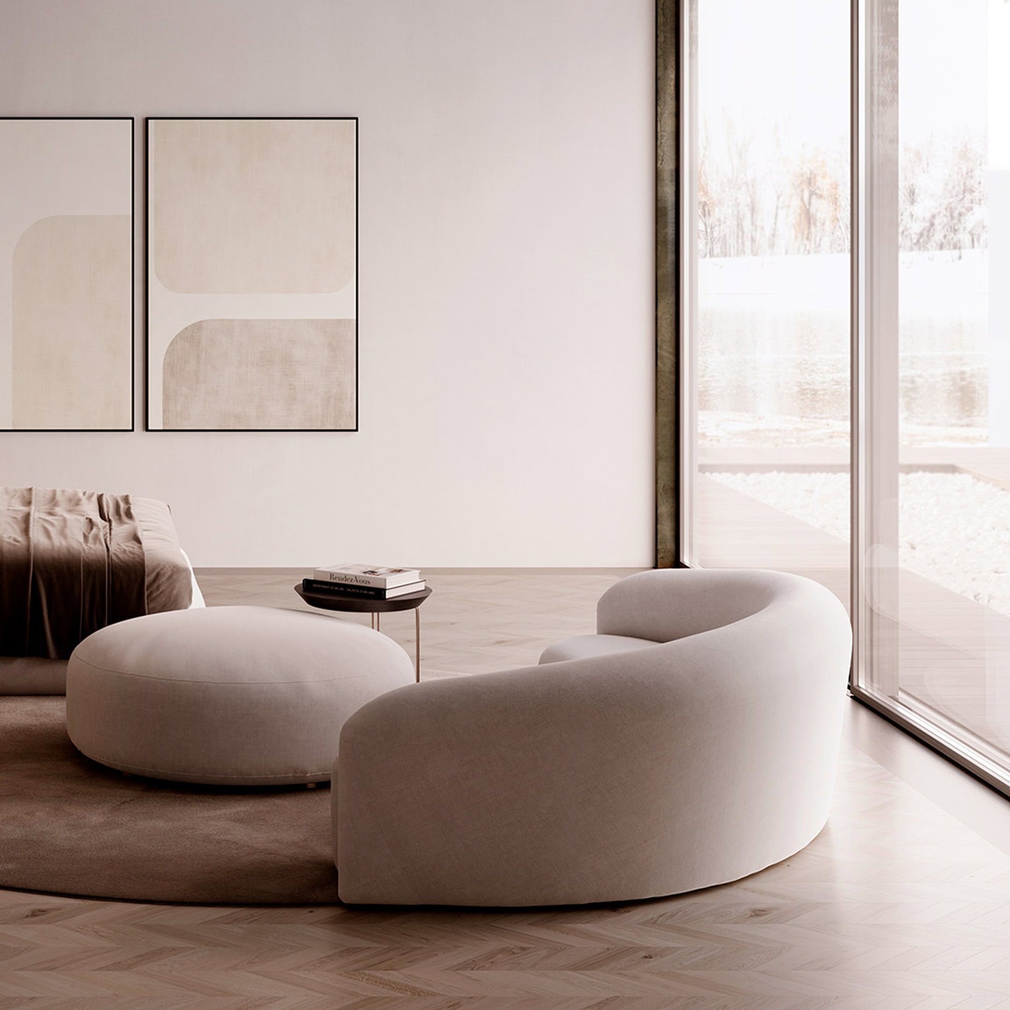 a round white couch in a room with a round table and artwork