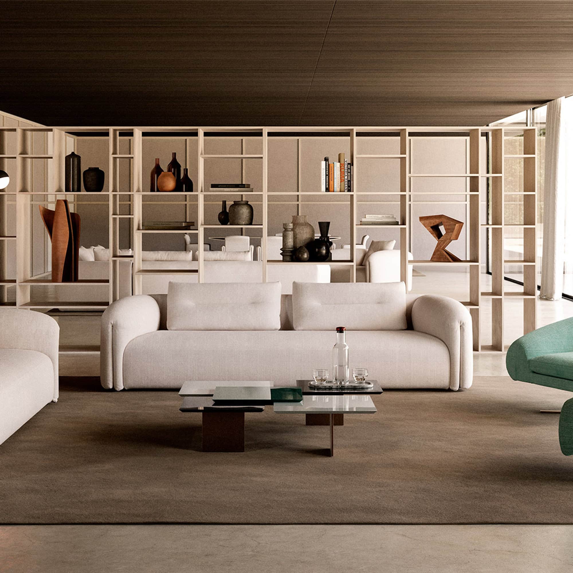 Quentin Linear Sofa in a contemporary living room with neutral tones and modern shelving backdrop.