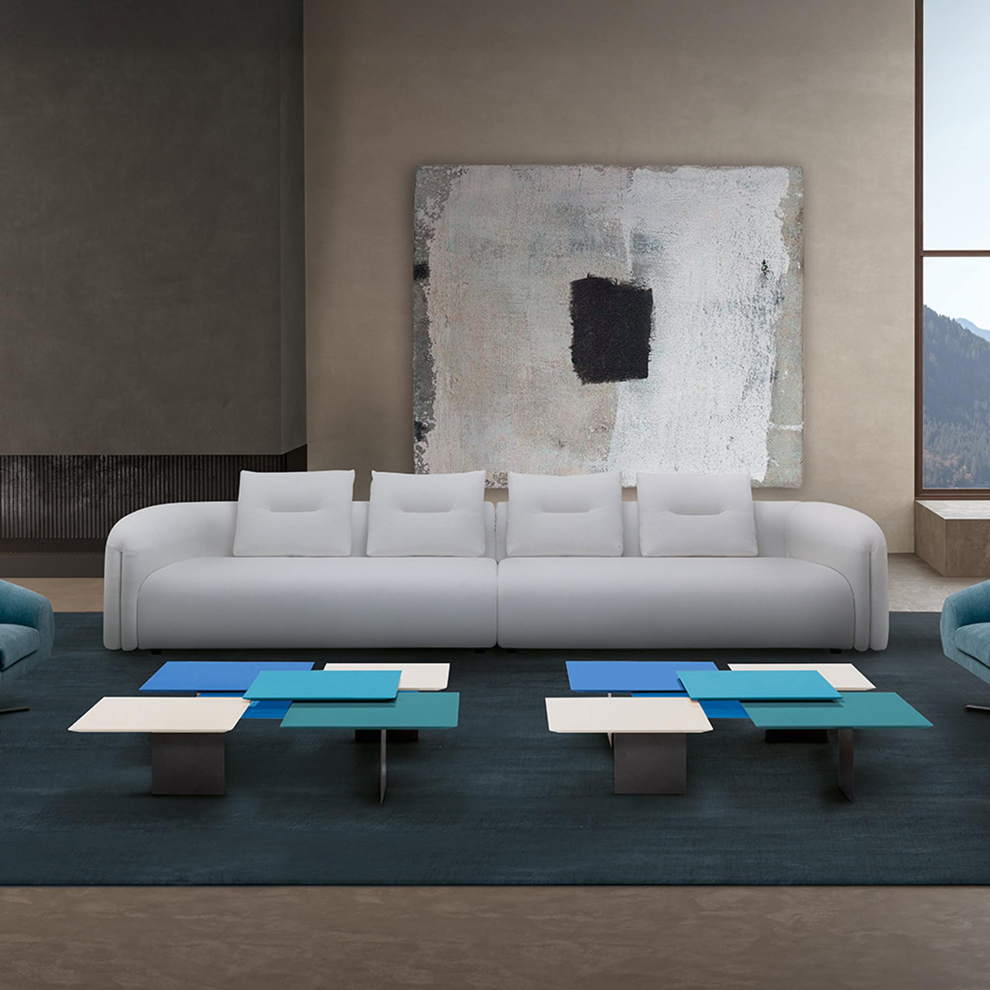 Quentin Linear Sofa in white fabric placed against a raw concrete wall for a minimalist look.