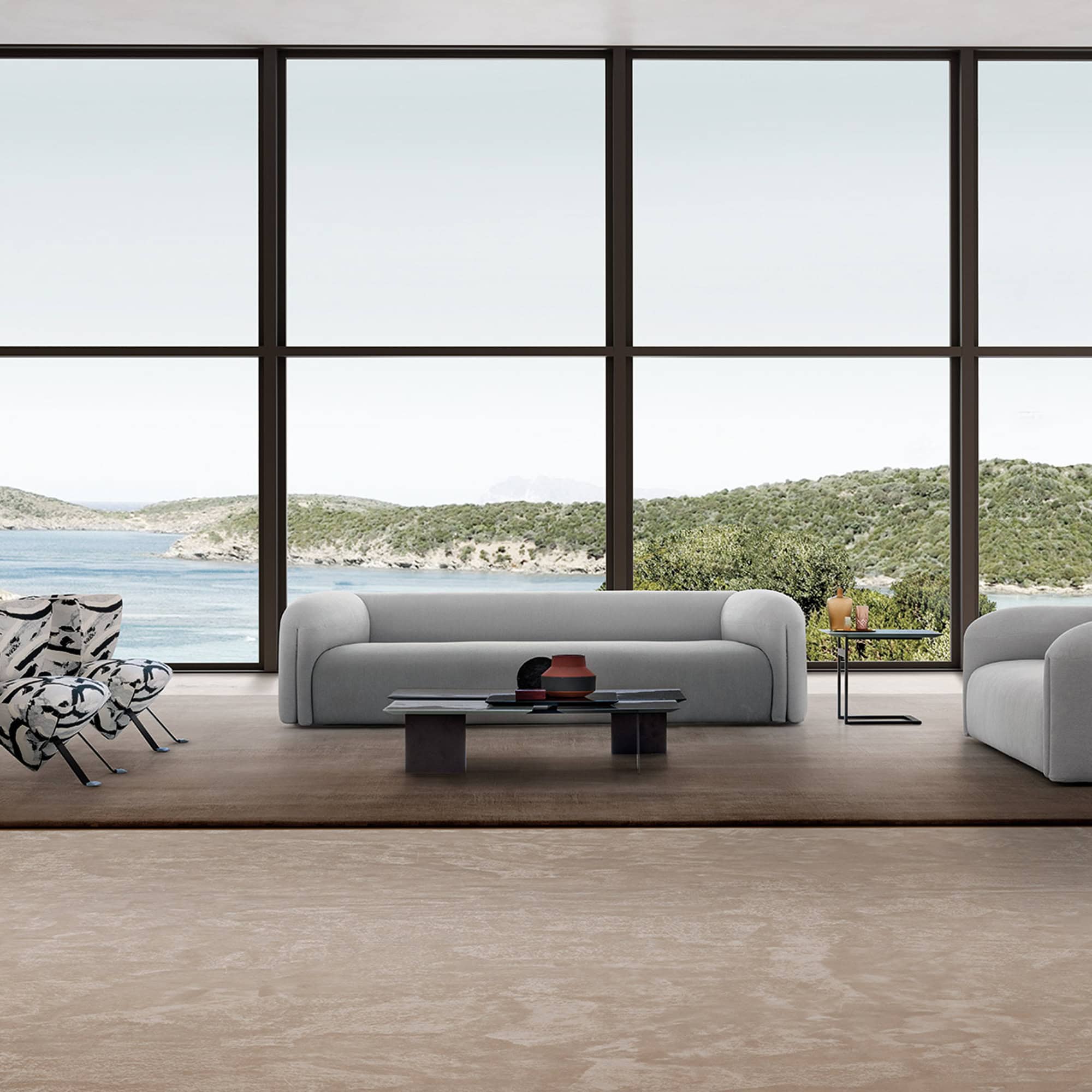 Quentin Linear Sofa in neutral grey tones, paired with modern coffee tables in a coastal-inspired interior.
