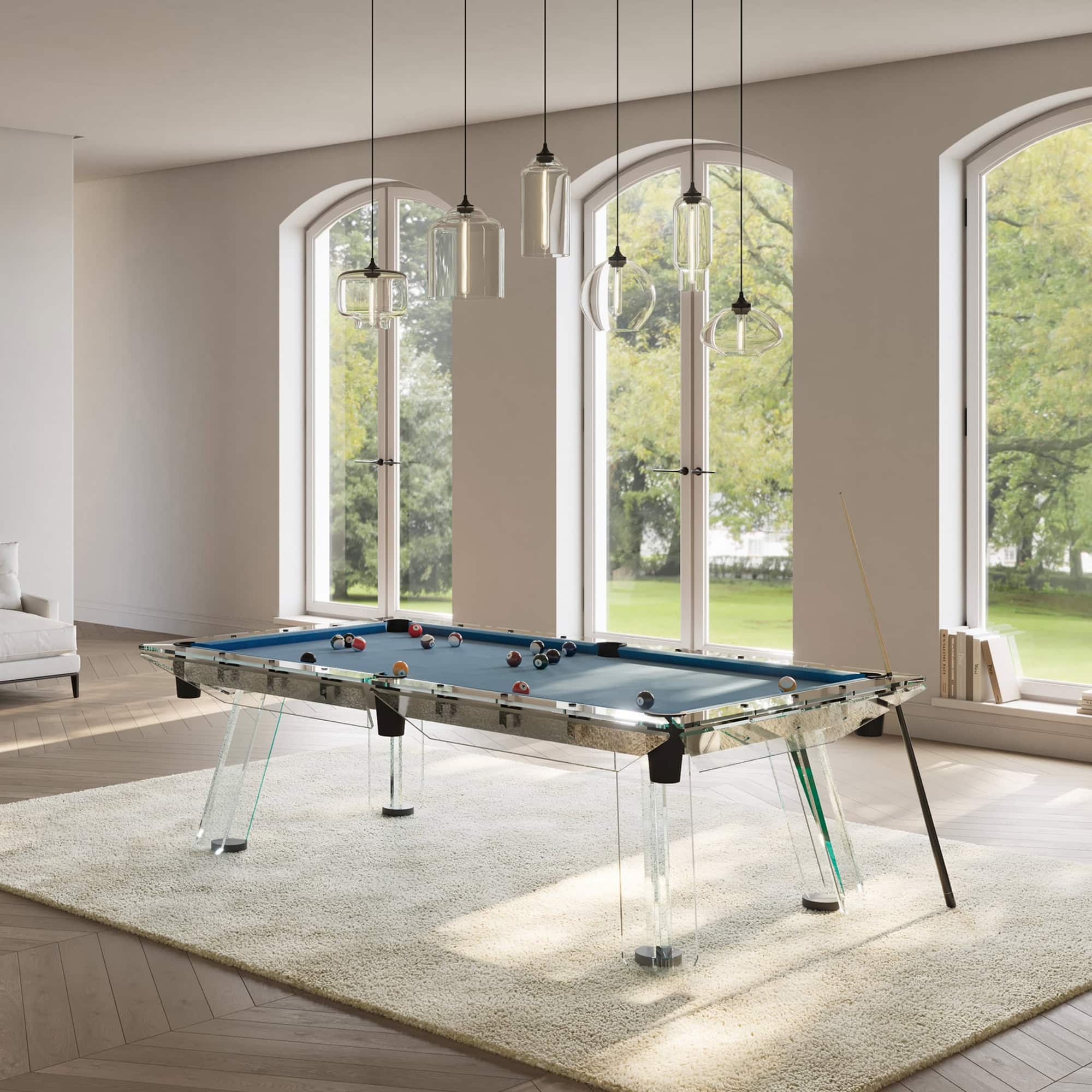 a pool table in a room with windows