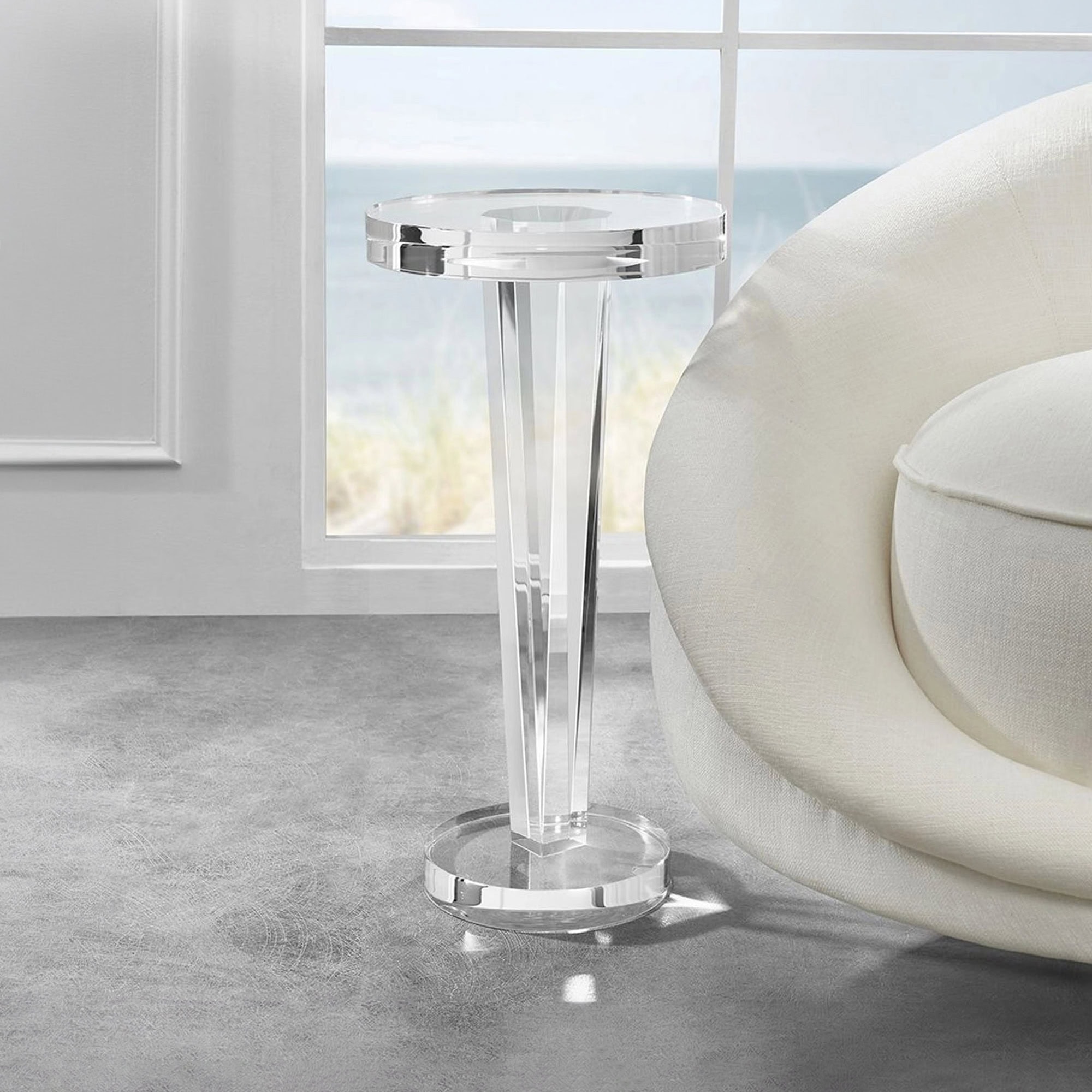Modern clear acrylic side table with sleek design in a bright living room.
