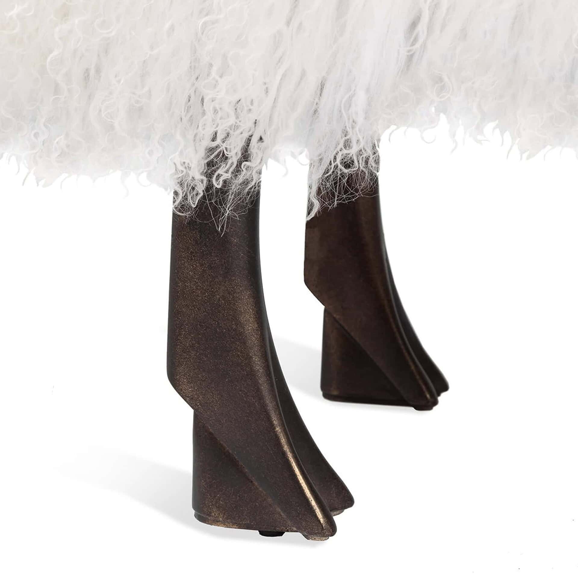 Close-up of antique bronze legs on the Phillippe Sheep Statue upholstered in ivory sheepskin.