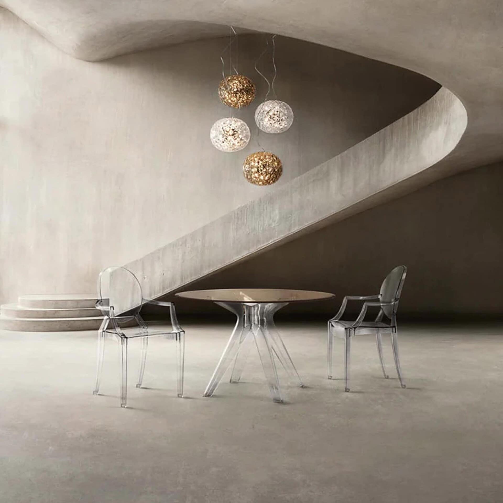 Louis Ghost Chairs in a modern dining setting with sculptural pendant lighting
