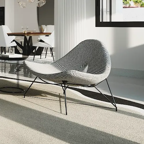 A modern black and white houndstooth lounge chair with thin black legs sits on a light rug in a sunlit room. A dining area is blurred in the background.