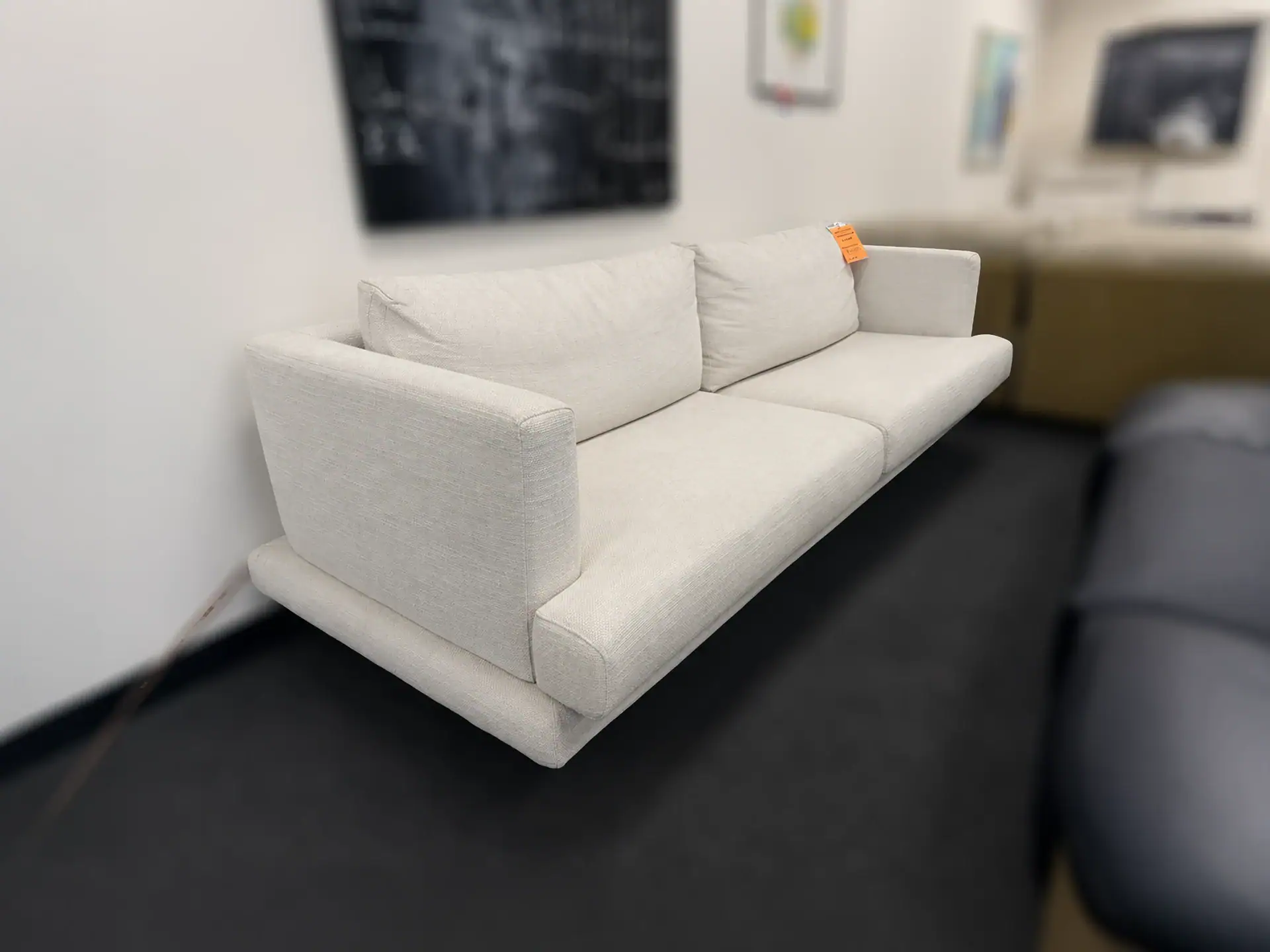 Modern white Mercury sofa by Sklar Furnishings in showroom.