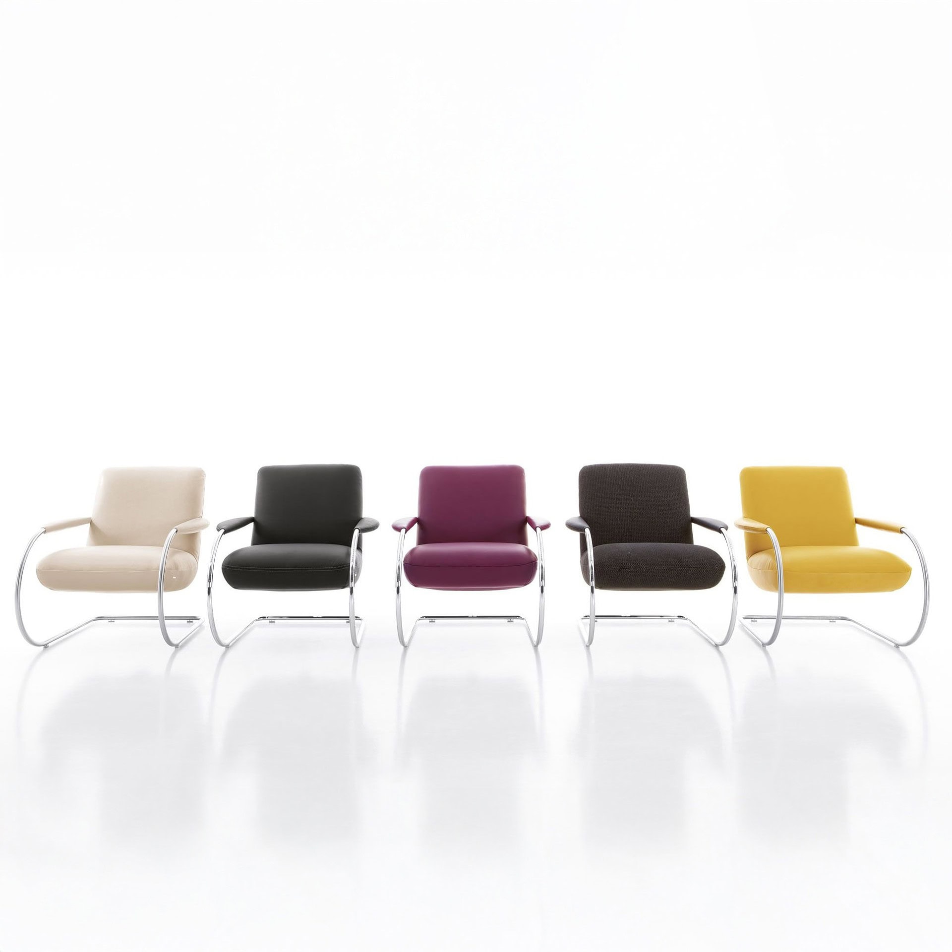 Group of Jumper Cantilever Armchairs in various colors, lined up in a row.