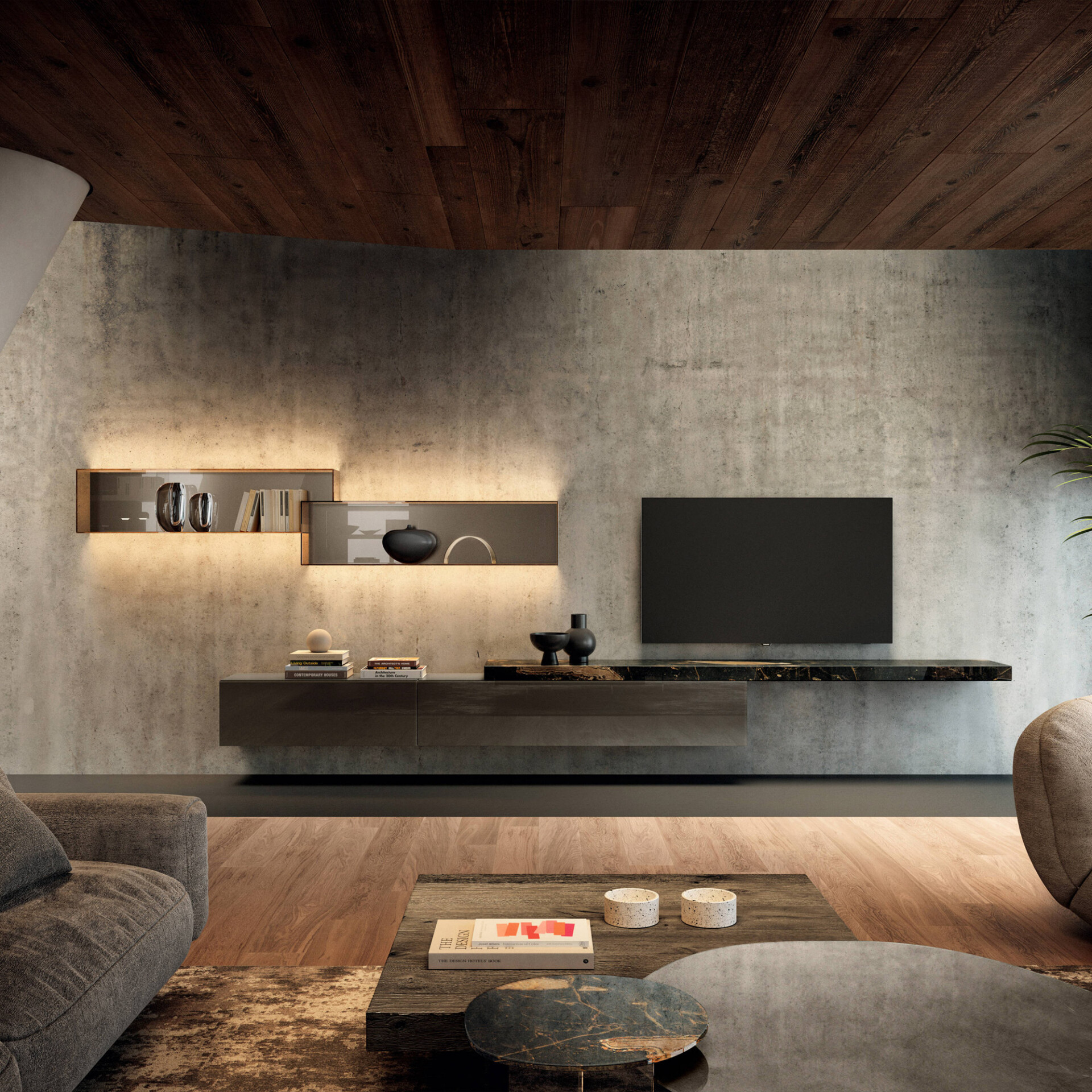 A modern living room with concrete walls, dark wood ceiling, and light wood floors. Features a floating media console with backlit display shelves, a flat-screen TV, and a multi-level coffee table with marble tops. A dark grey sofa and a light brown armchair are partially visible.