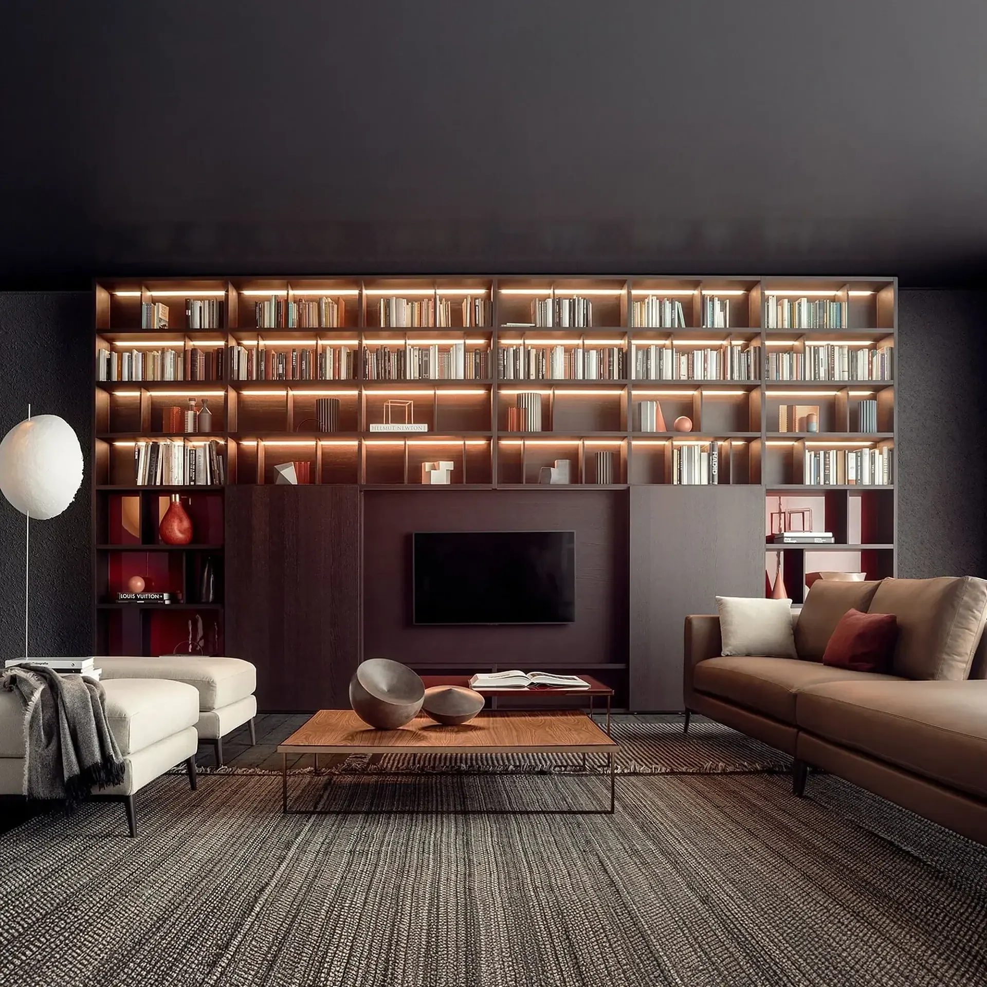 Living room with dark wood wall-to-wall bookcase and mounted TV.