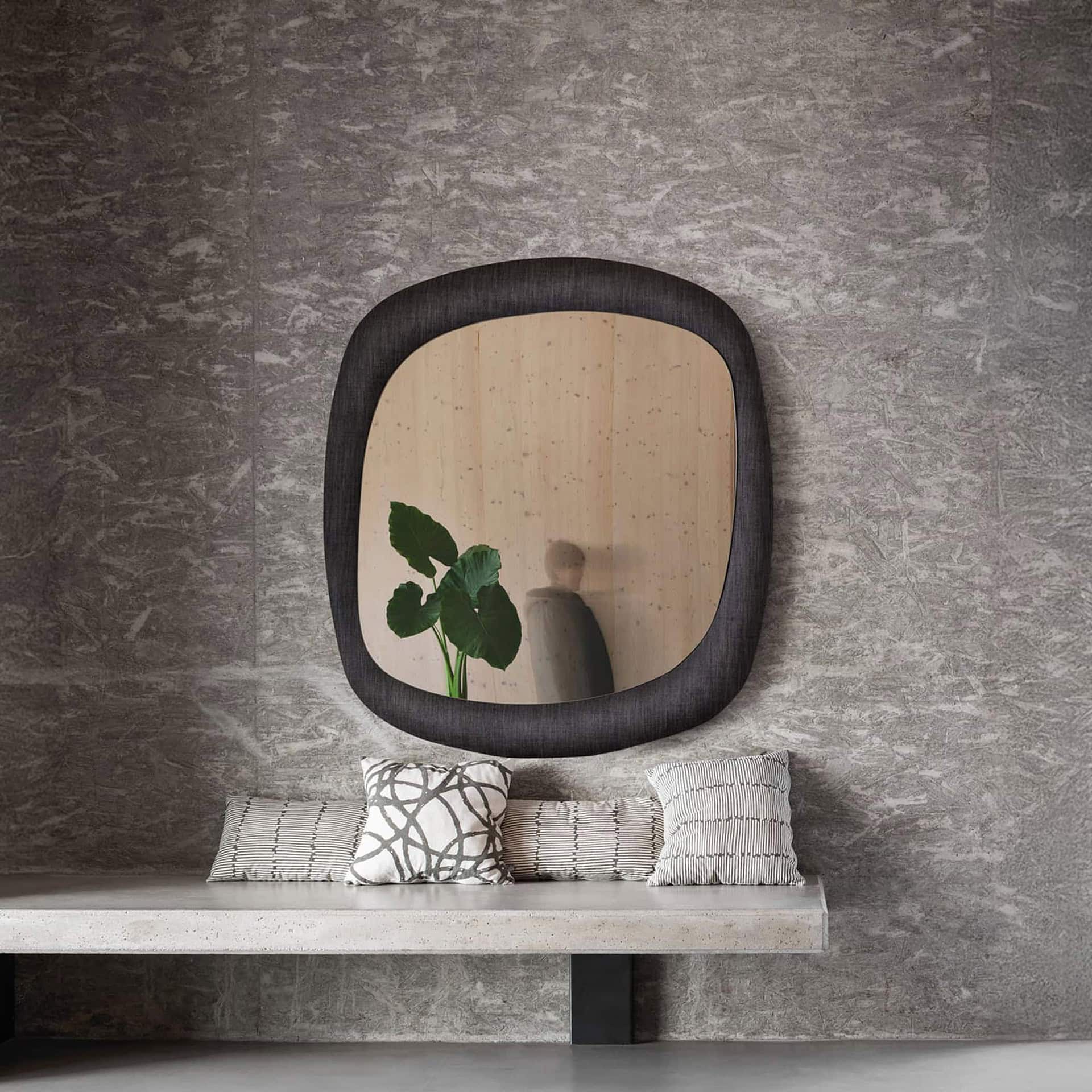 Bold Curved Wall Mirror in a modern bathroom setting with rounded square shape and reflective glass.