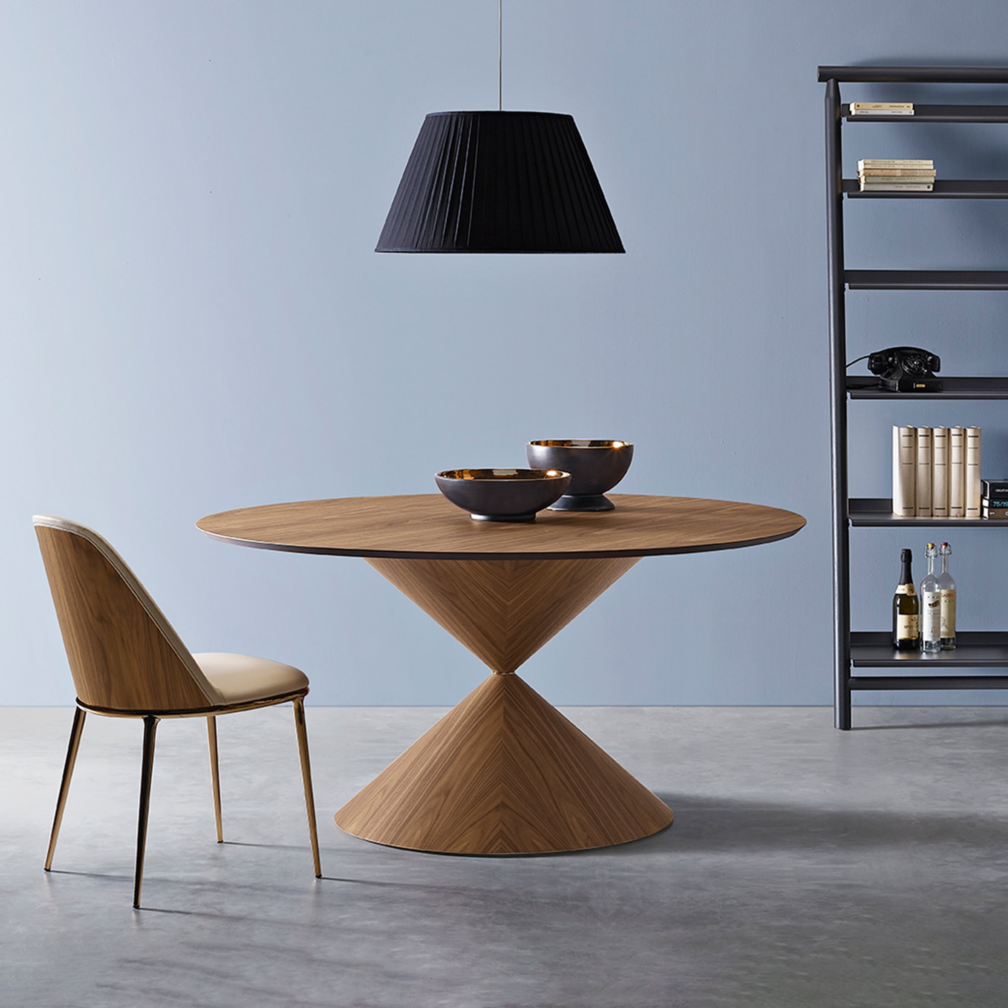 Stylish wooden dining table with contemporary black pendant light and minimalist shelving for modern.
