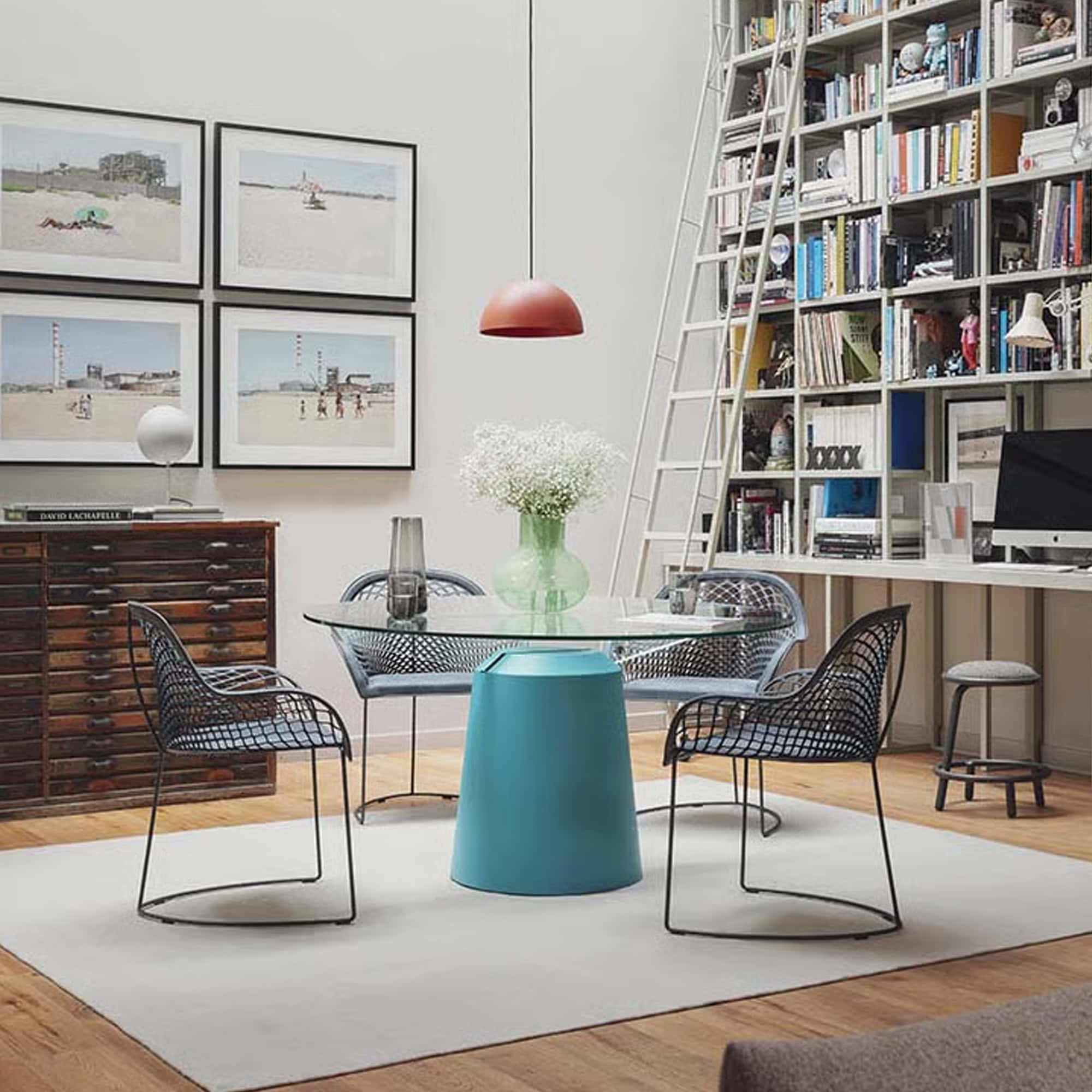 Guapa Leather Armchairs styled in a modern studio interior with bookshelves.