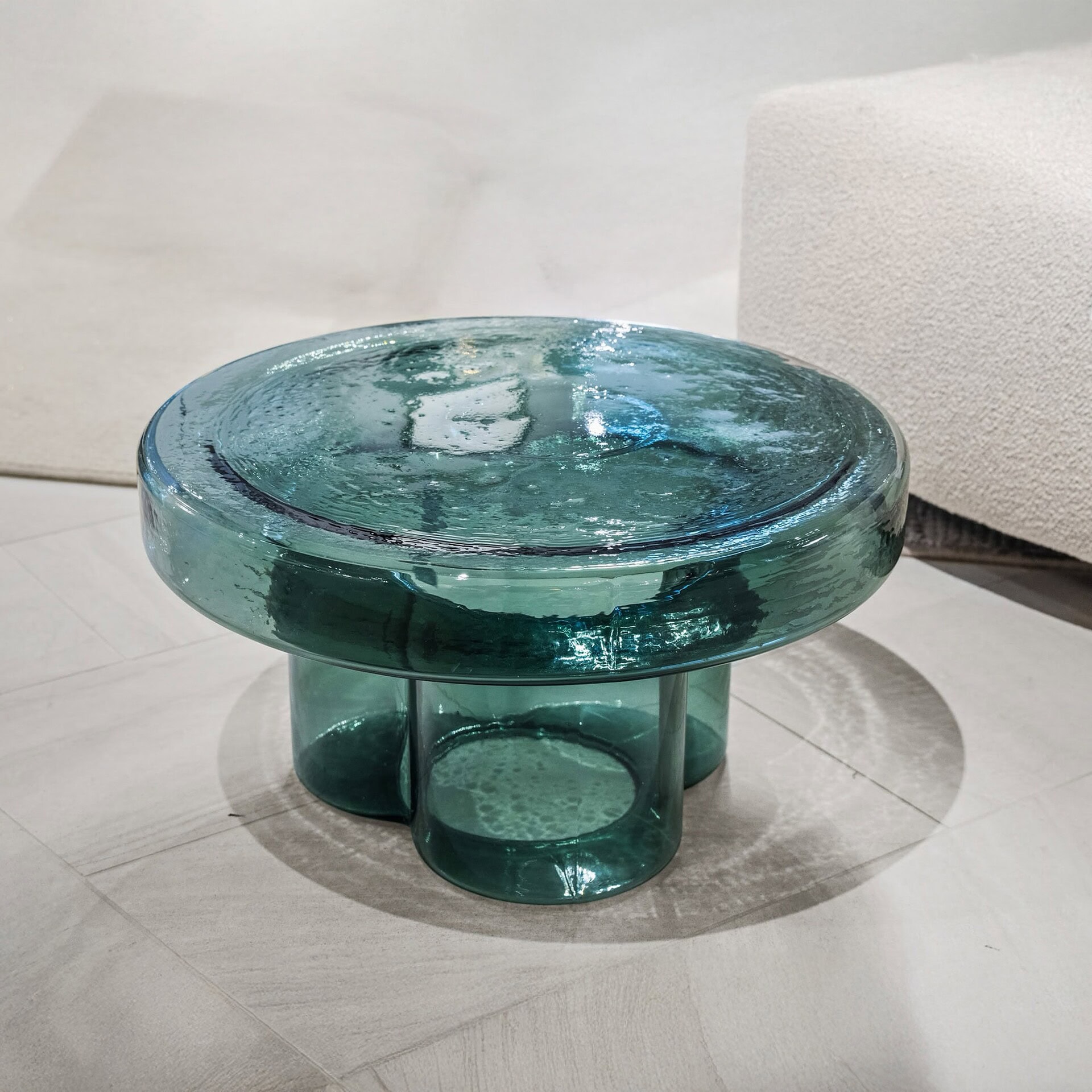 Elegant teal glass coffee table with modern design, perfect for stylish living rooms.