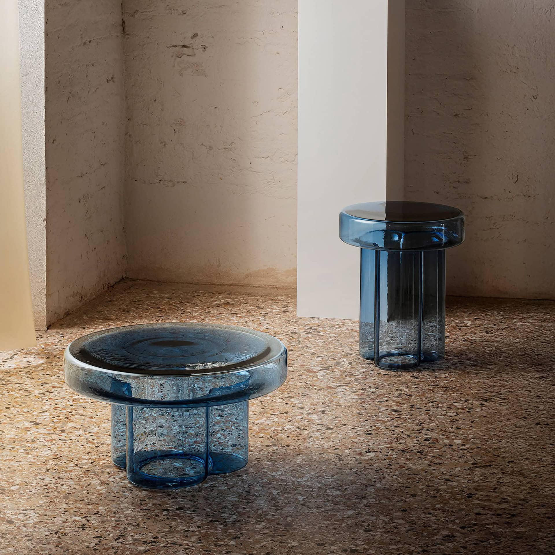 Soda Hand-Blown Glass Coffee Table in Blue blown glass against a textured stone floor