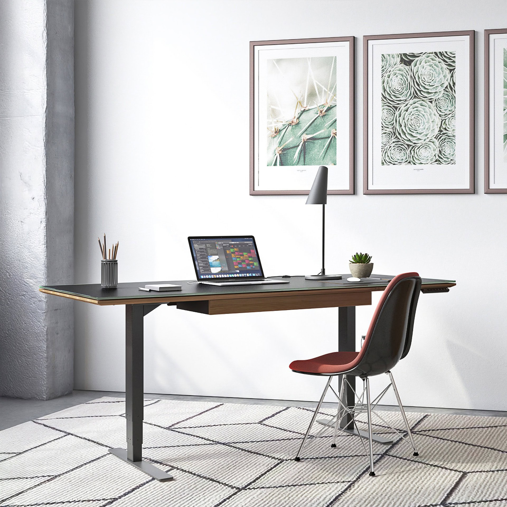 Sequel 20 6152 Sit-Stand Desk at seated height in a modern office with a red chair and framed artwork on the wall.