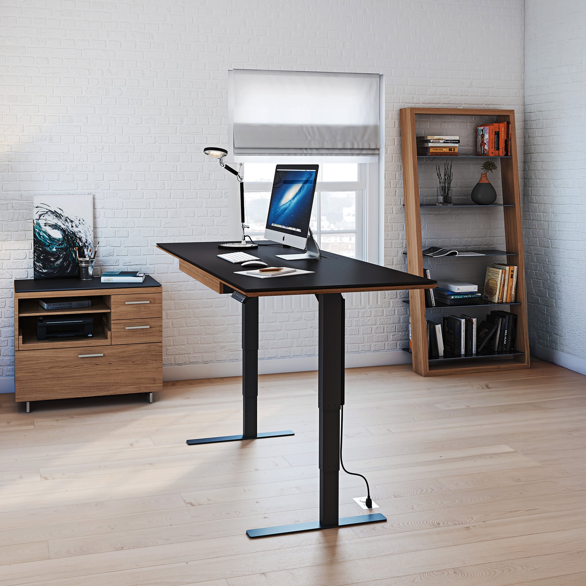 Sequel 20 6152 Sit-Stand Desk in a home office raised to standing height with a laptop and lamp on the surface.