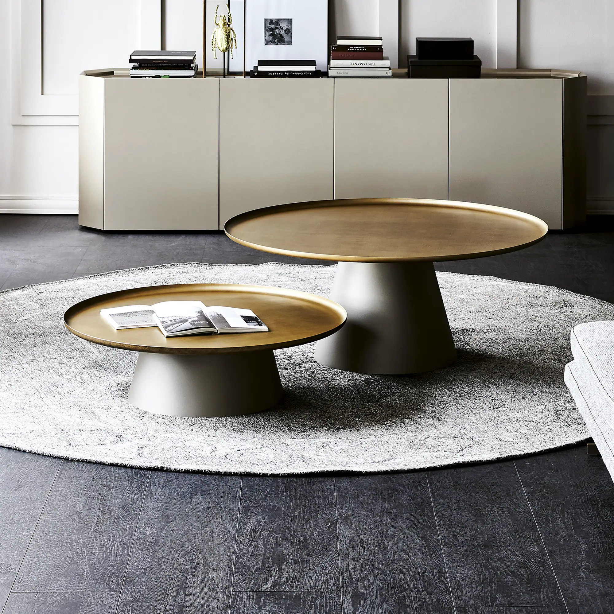 Cattelan Italia Amerigo Round Coffee Table in brushed bronze finish with mirrored top, styled in a modern living room.