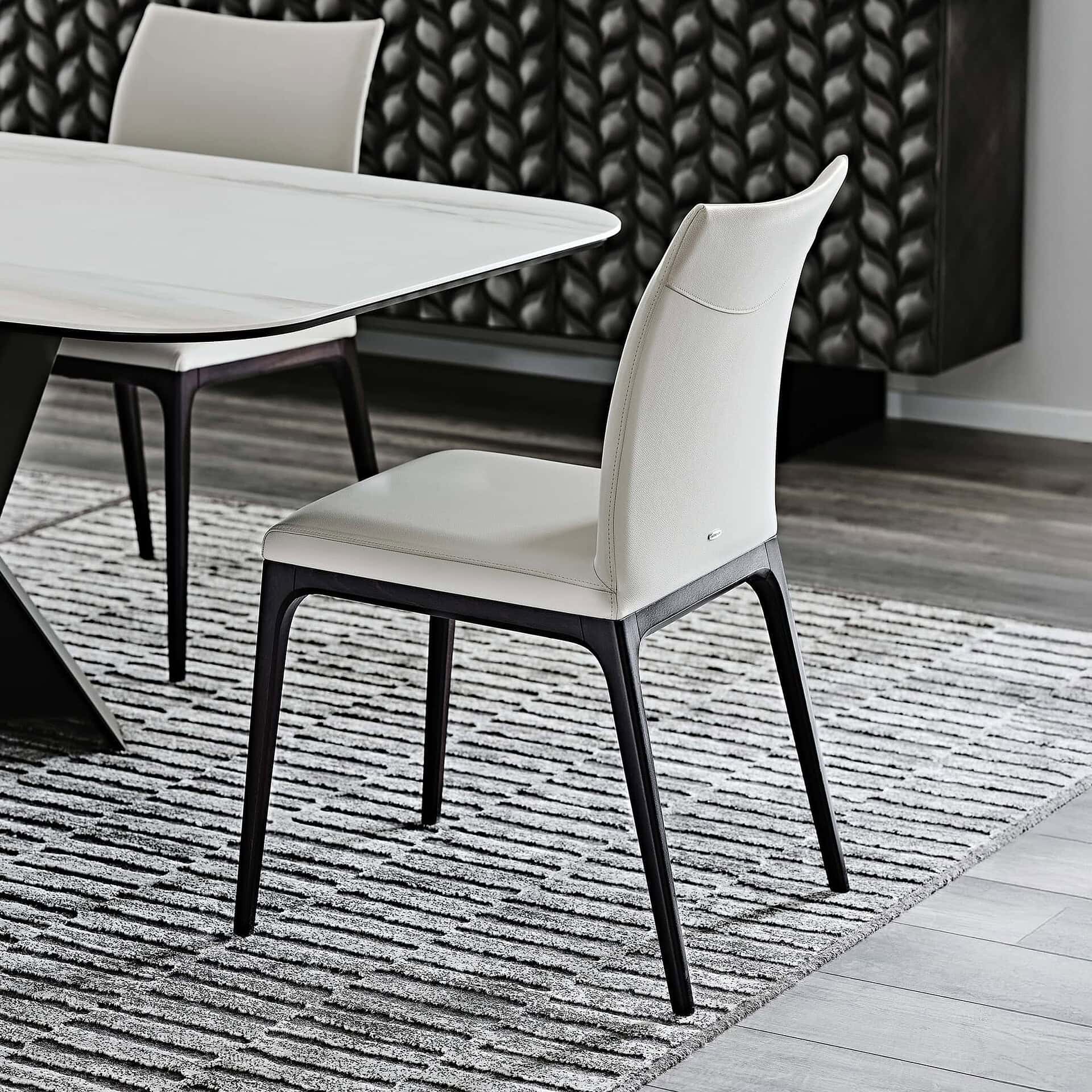 Sleek modern dining chair with black wood legs and white upholstery for stylish home décor.