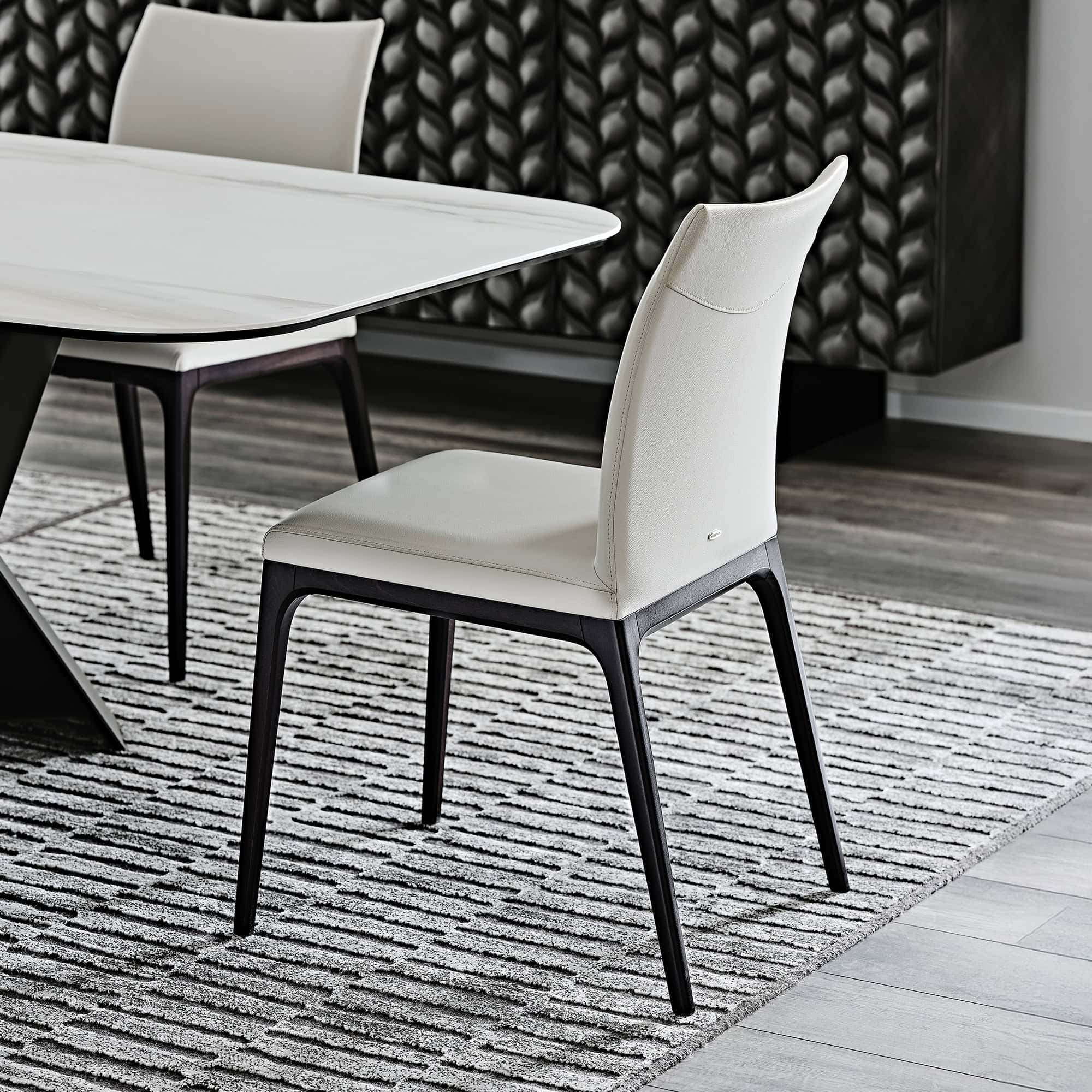 Sleek modern dining chair with black wood legs and white upholstery for stylish home décor.