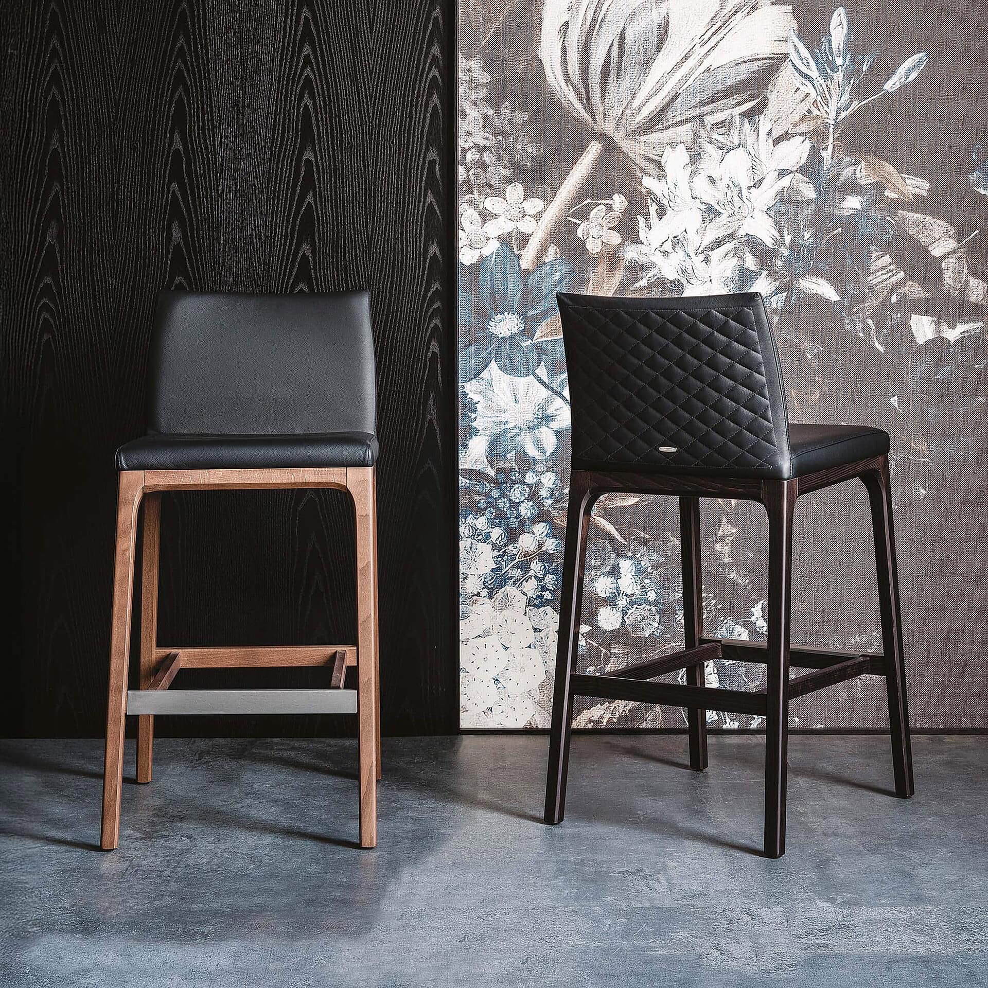 Contemporary black and wood upholstered dining chairs at Sklar Furnishings showroom.