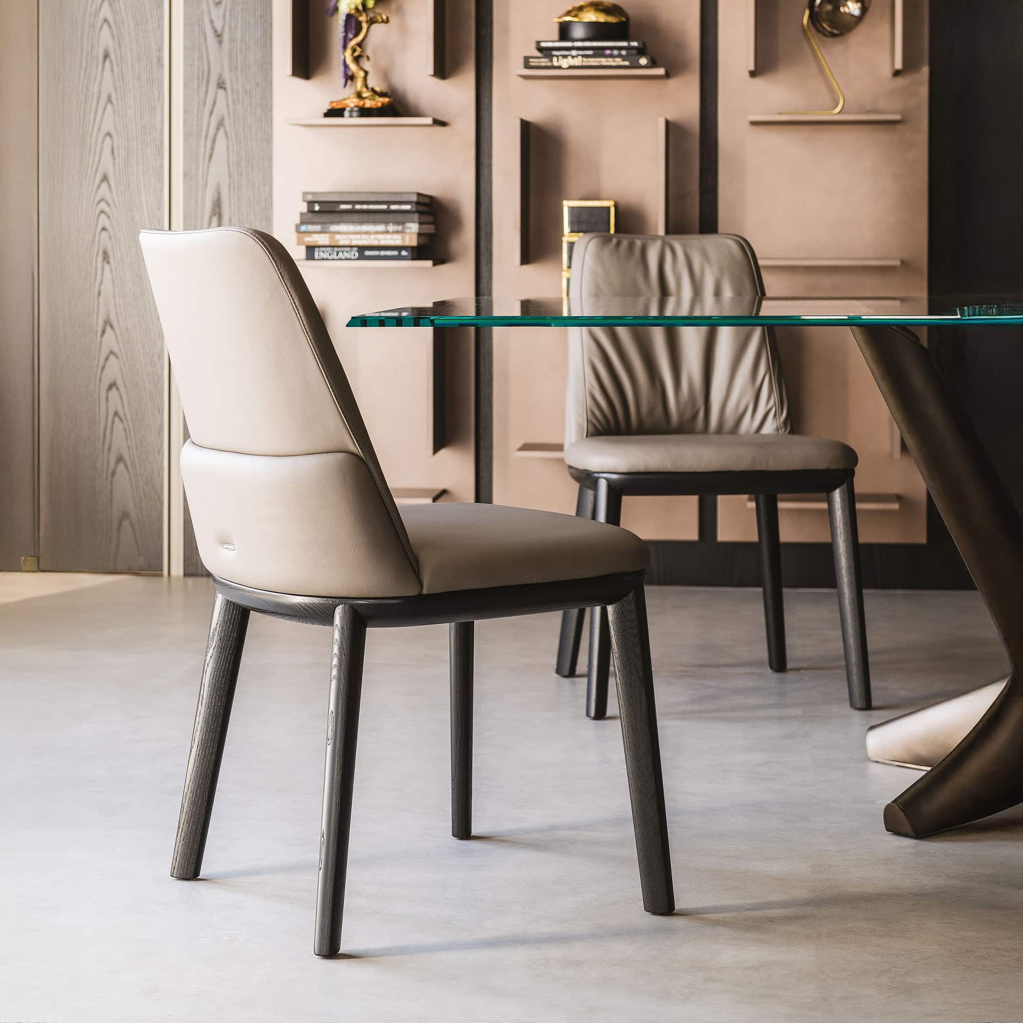 Two Belinda Dining Chairs in neutral tones with black ashwood frames.