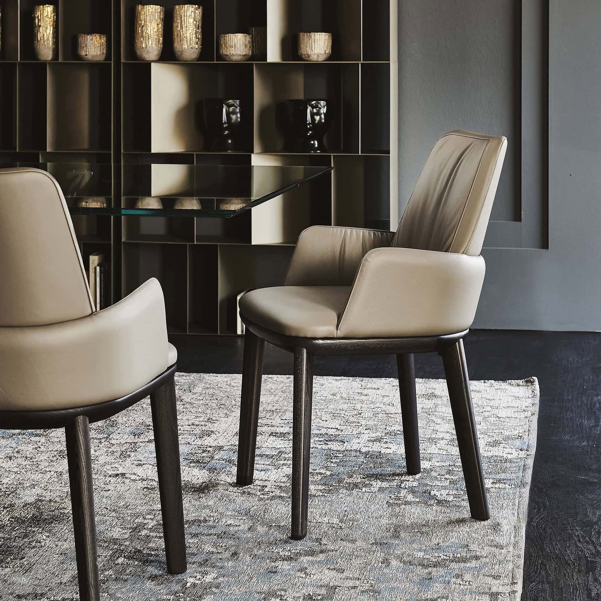 Modern leather dining chairs with dark wood legs for contemporary home decor.