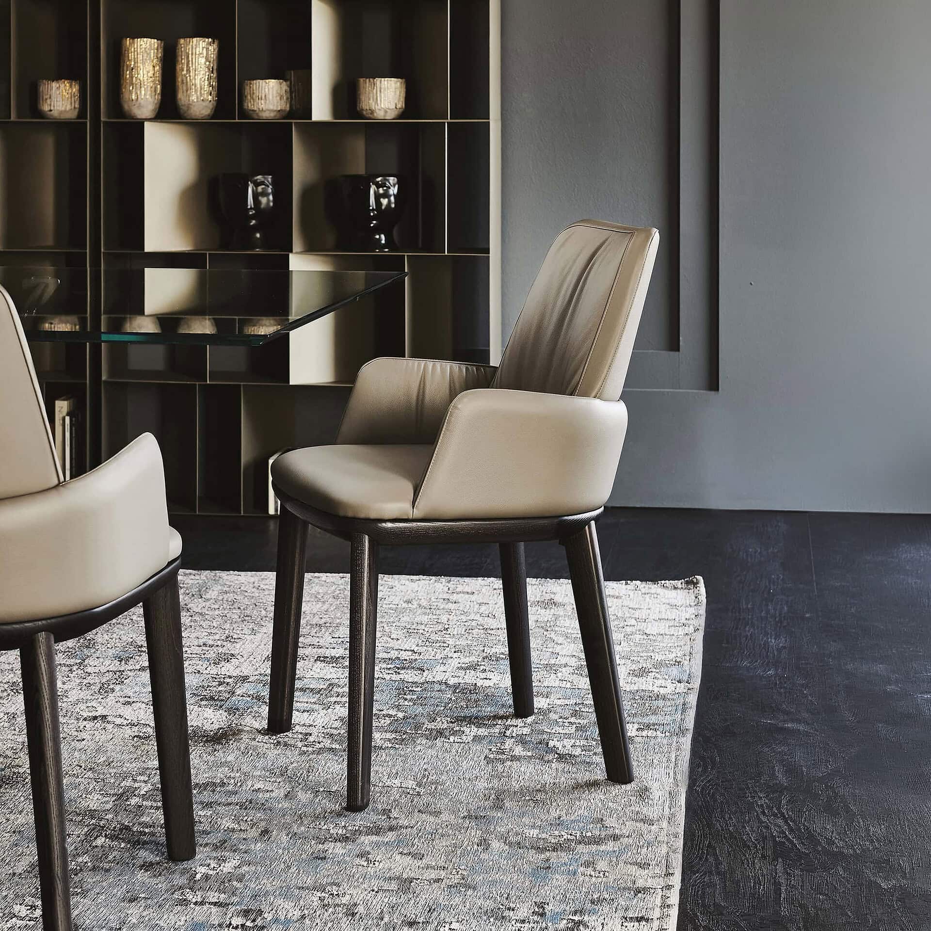 Modern leather dining chairs with dark wood legs for contemporary home decor.