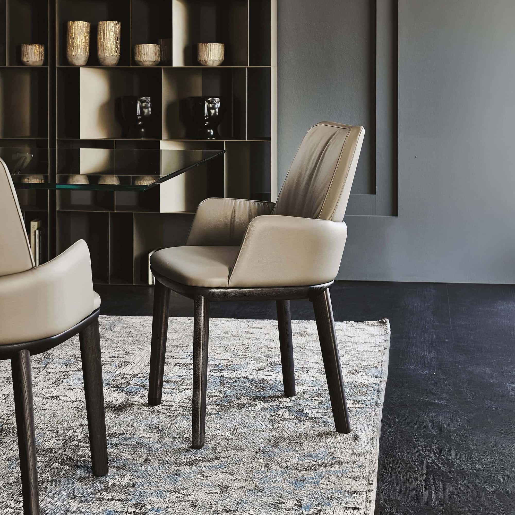 Modern leather dining chairs with dark wood legs for contemporary home decor.
