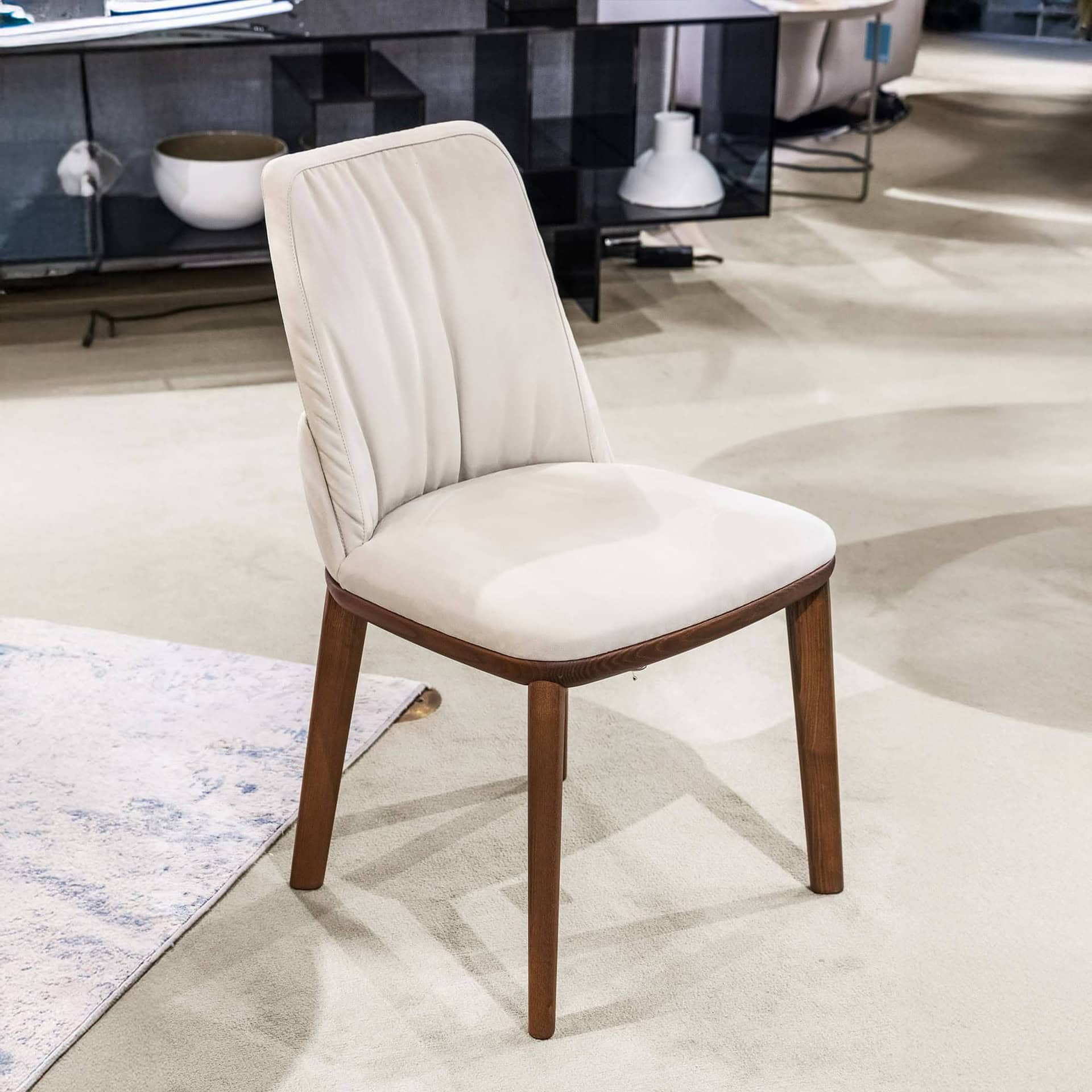 Upholstered dining chair with wooden legs, elegant modern furniture for homes or restaurants.