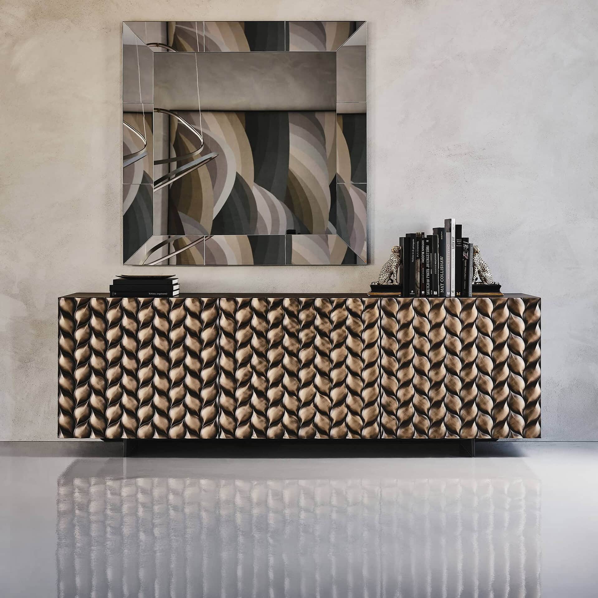 Contemporary sideboard with a textured, metallic finish and decorative accents in a modern interior.