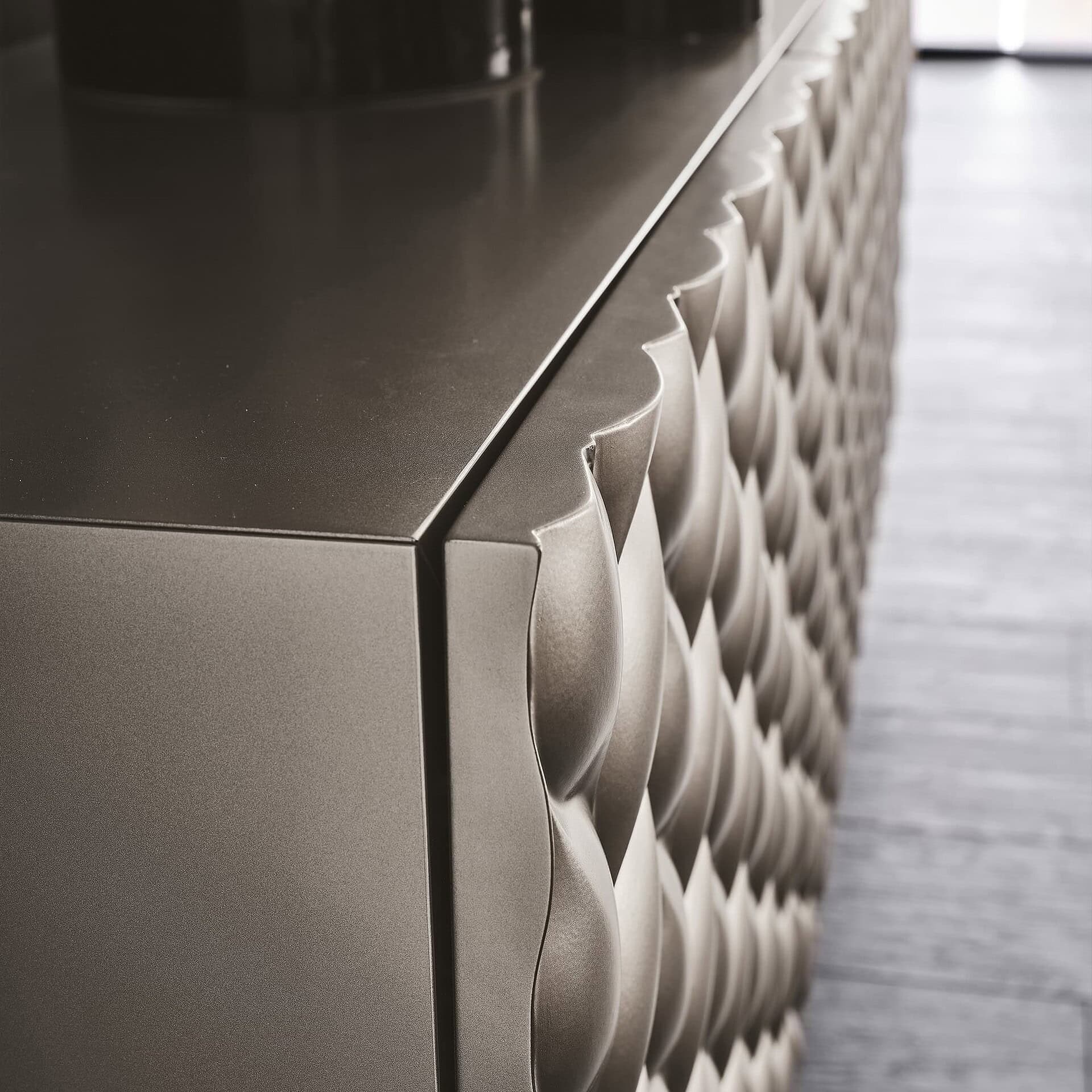 Sleek metallic cabinet with textured 3D geometric pattern, modern and luxurious in design.