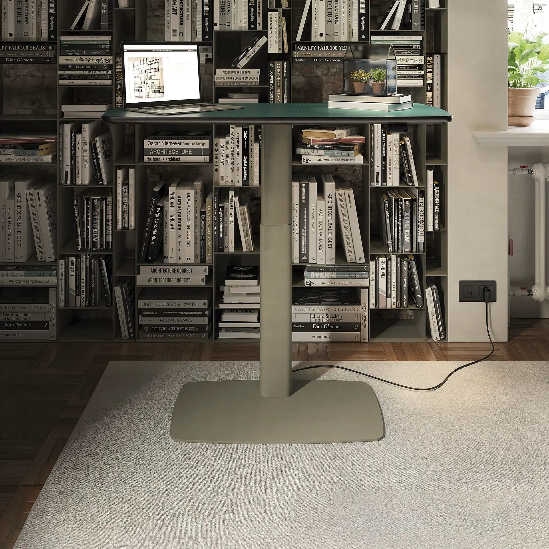 Runner height-adjustable desk with a green top in front of a bookshelf.