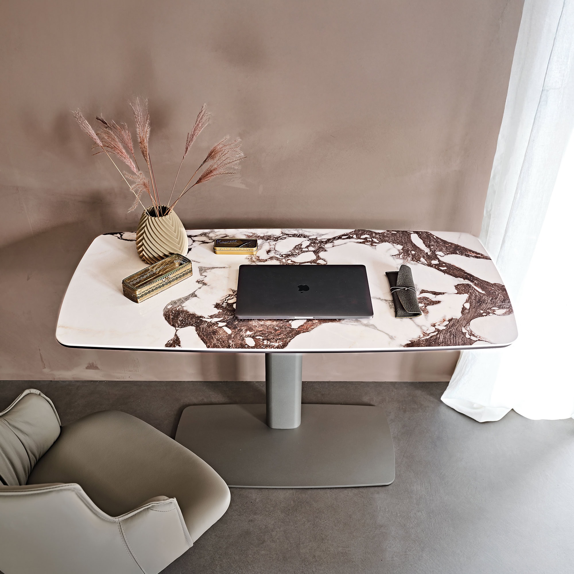 Elegant marble dining table with pink and brown accents, modern design, and stylish decor.