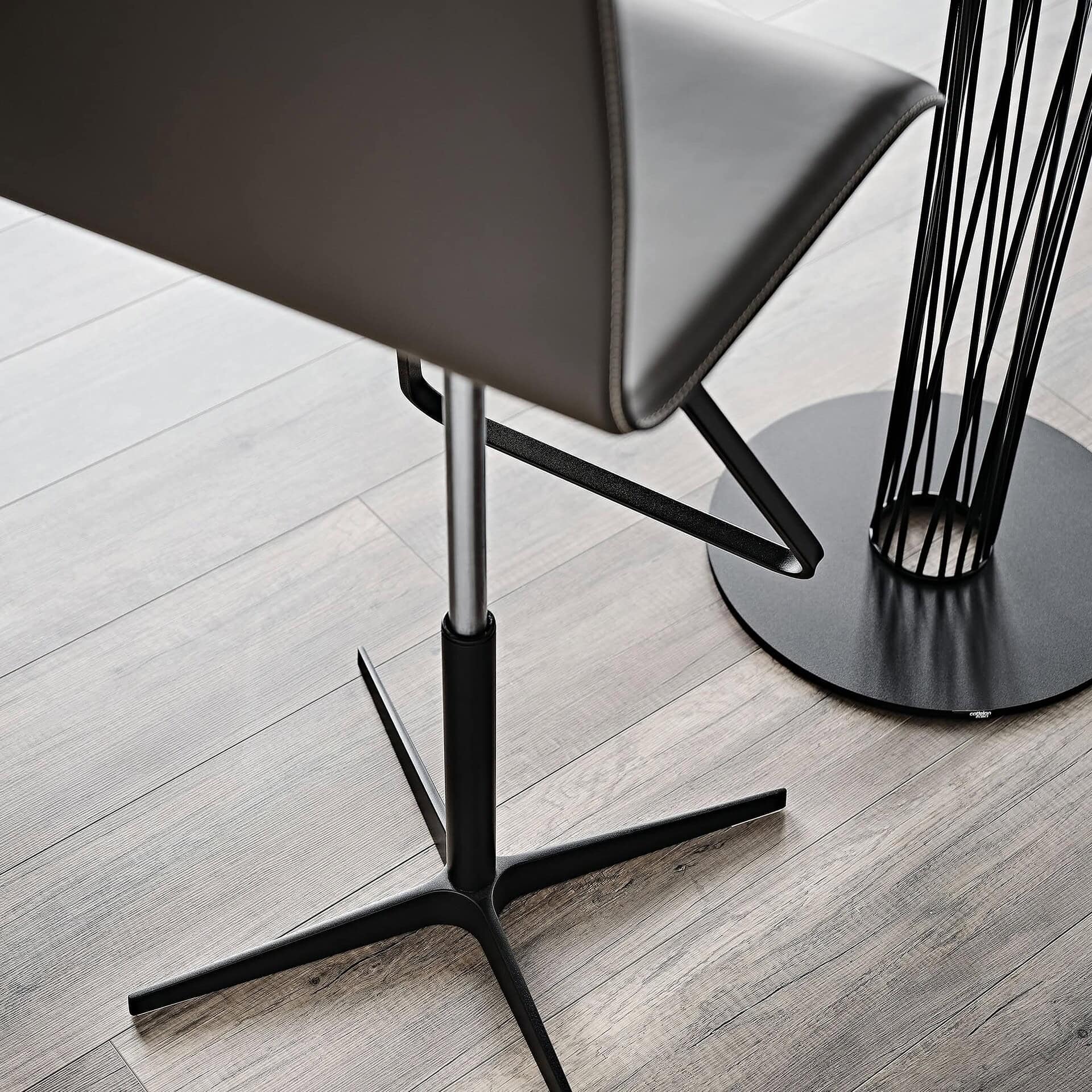 Modern black and metal dining chair with sleek design and sturdy base.