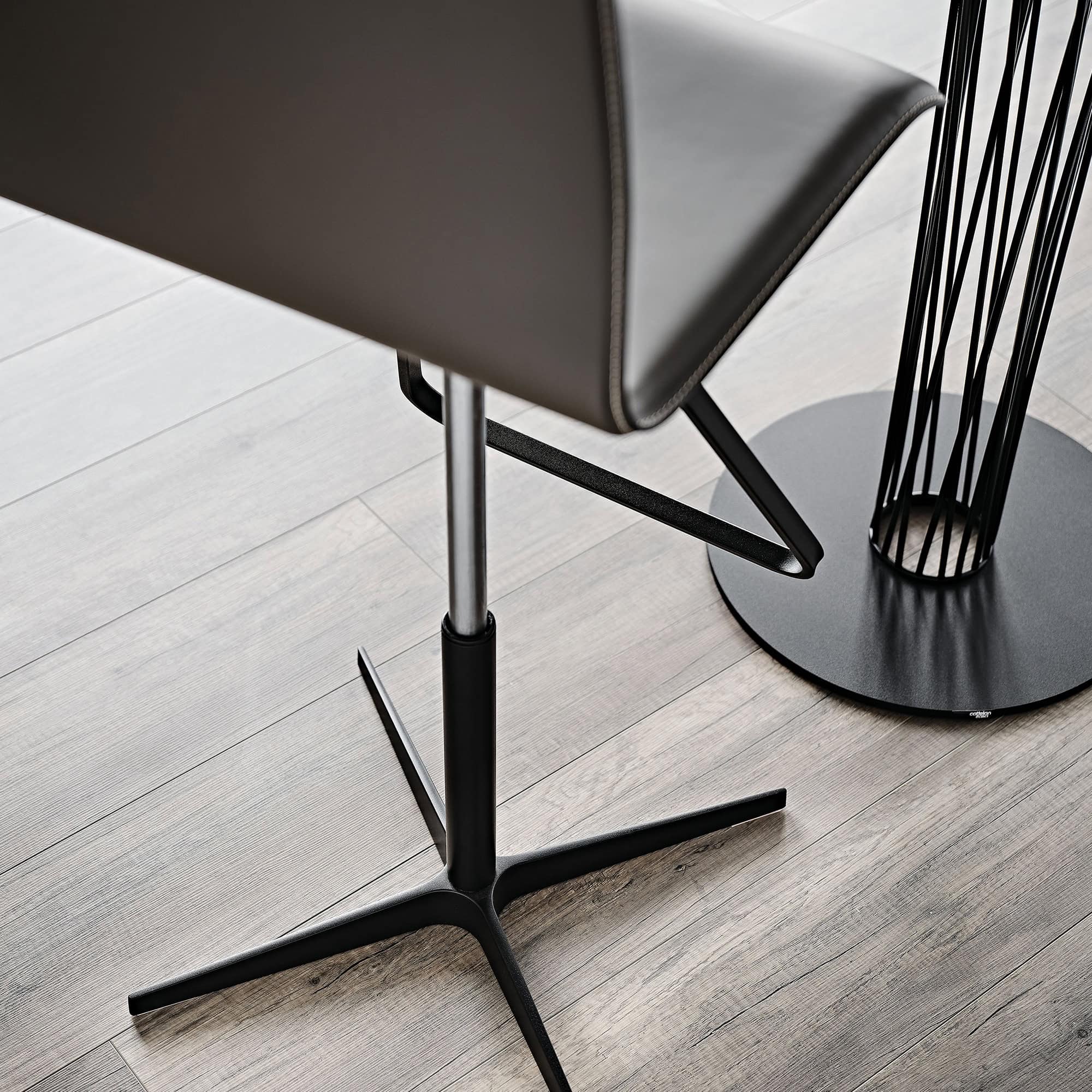 Modern black and metal dining chair with sleek design and sturdy base.