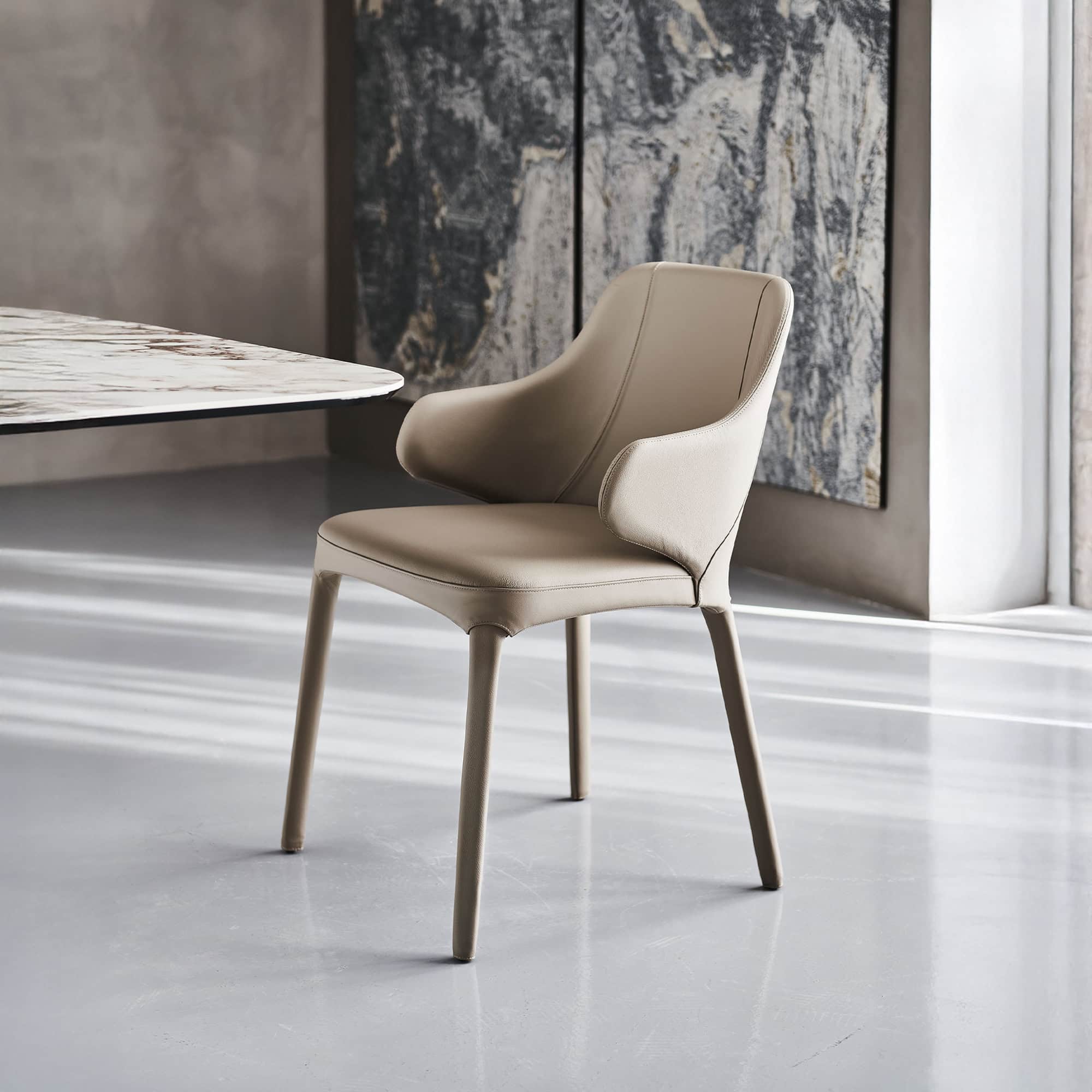 Wanda Dining Chair in soft beige leather with wooden legs, angled front view.
