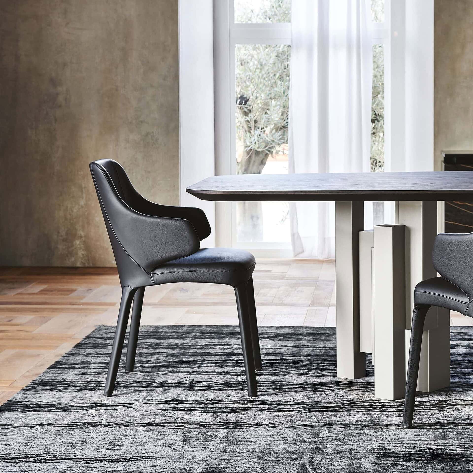 Contemporary black leather dining chairs with modern design at Sklar Furnishings.