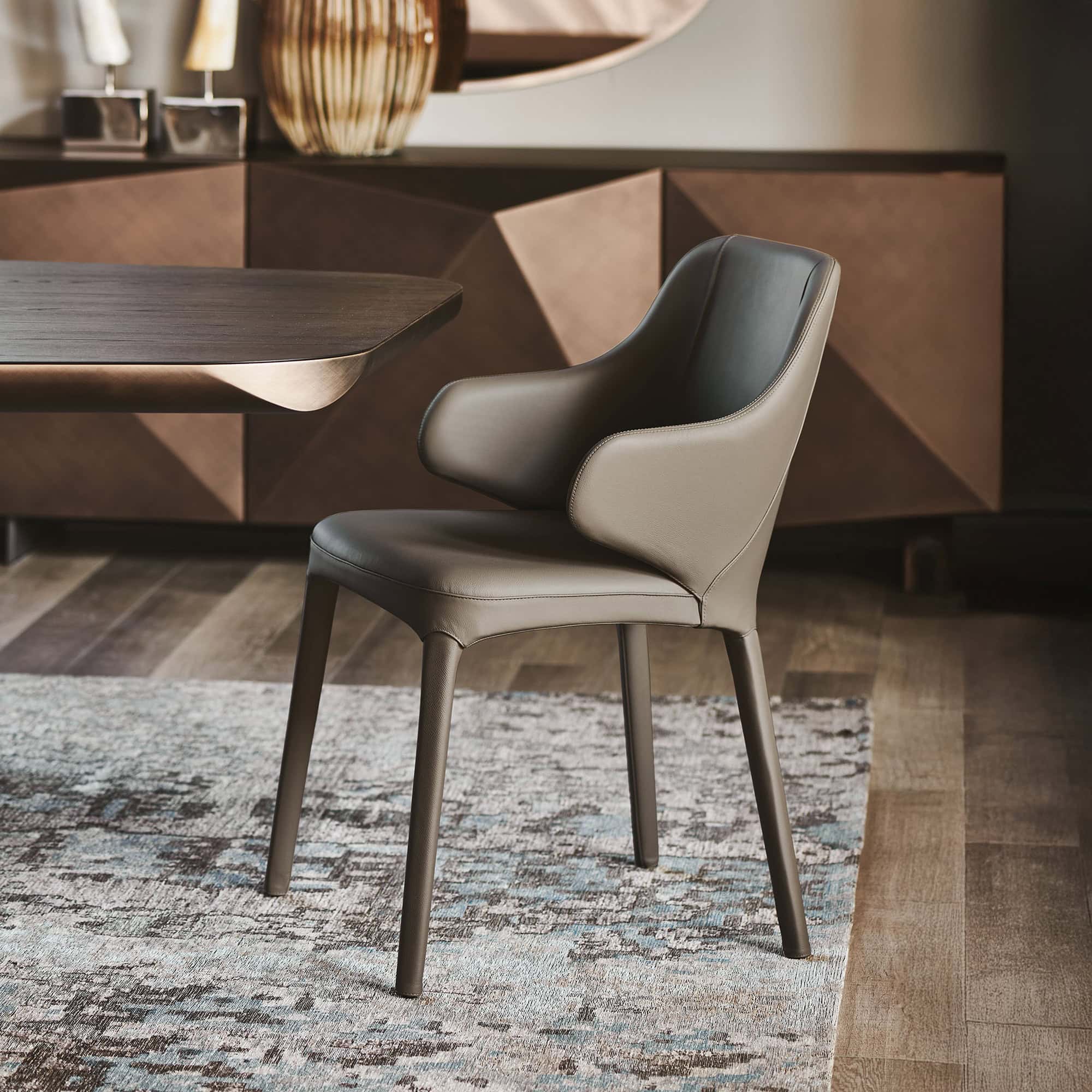 Luxurious modern dining chair with leather upholstery and sleek design by Sklar Furnishings.