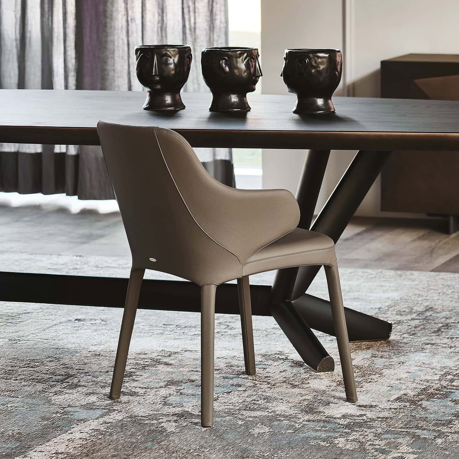 Elegant modern dining chair with beige upholstery and sleek design for stylish interiors.