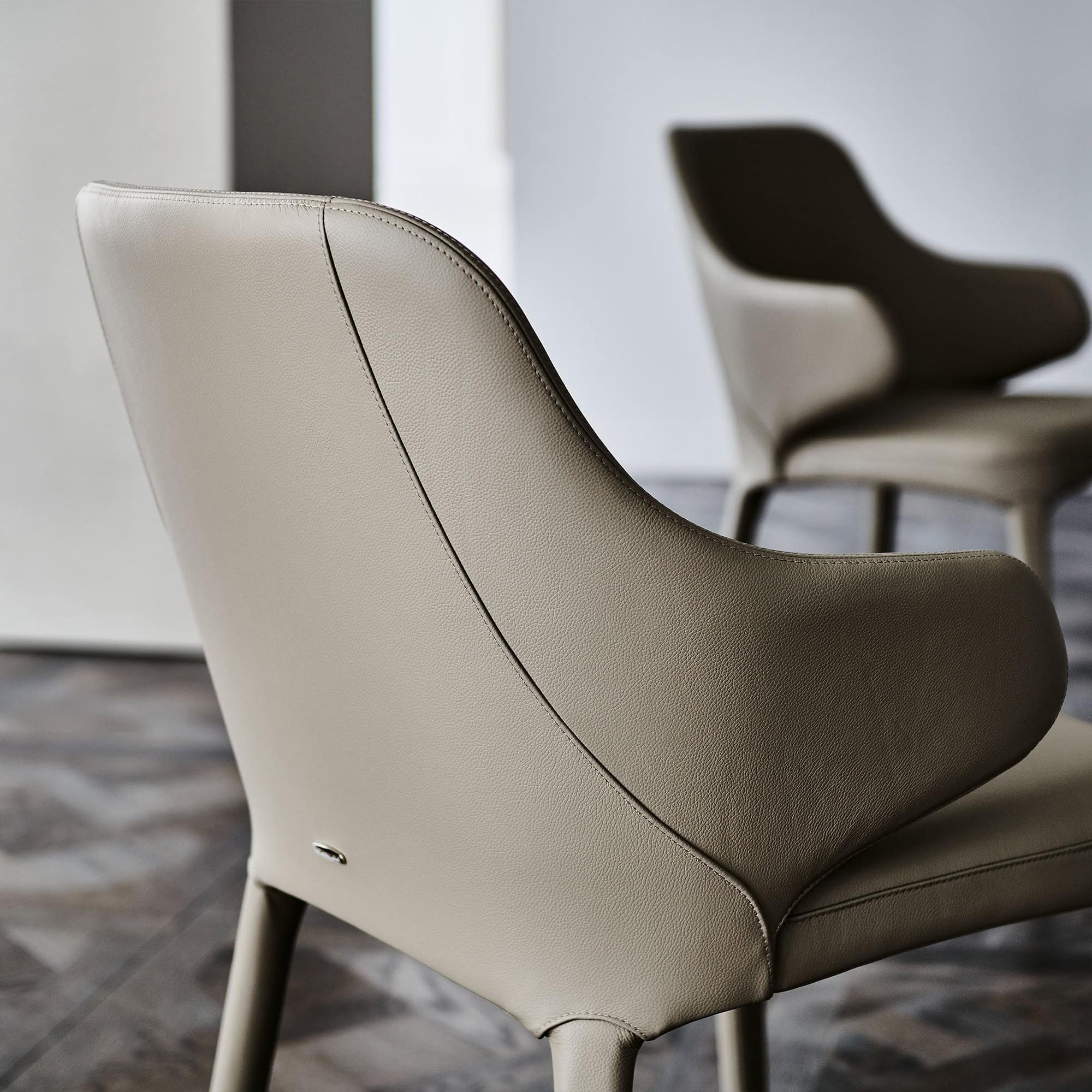Modern beige leather accent chair for stylish living room interior.