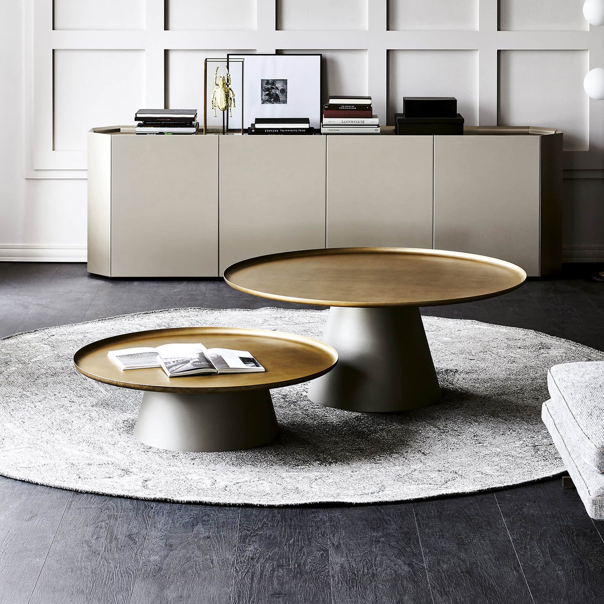 Cattelan Italia Amerigo Round Coffee Table in brushed bronze finish with mirrored top, styled in a modern living room.
