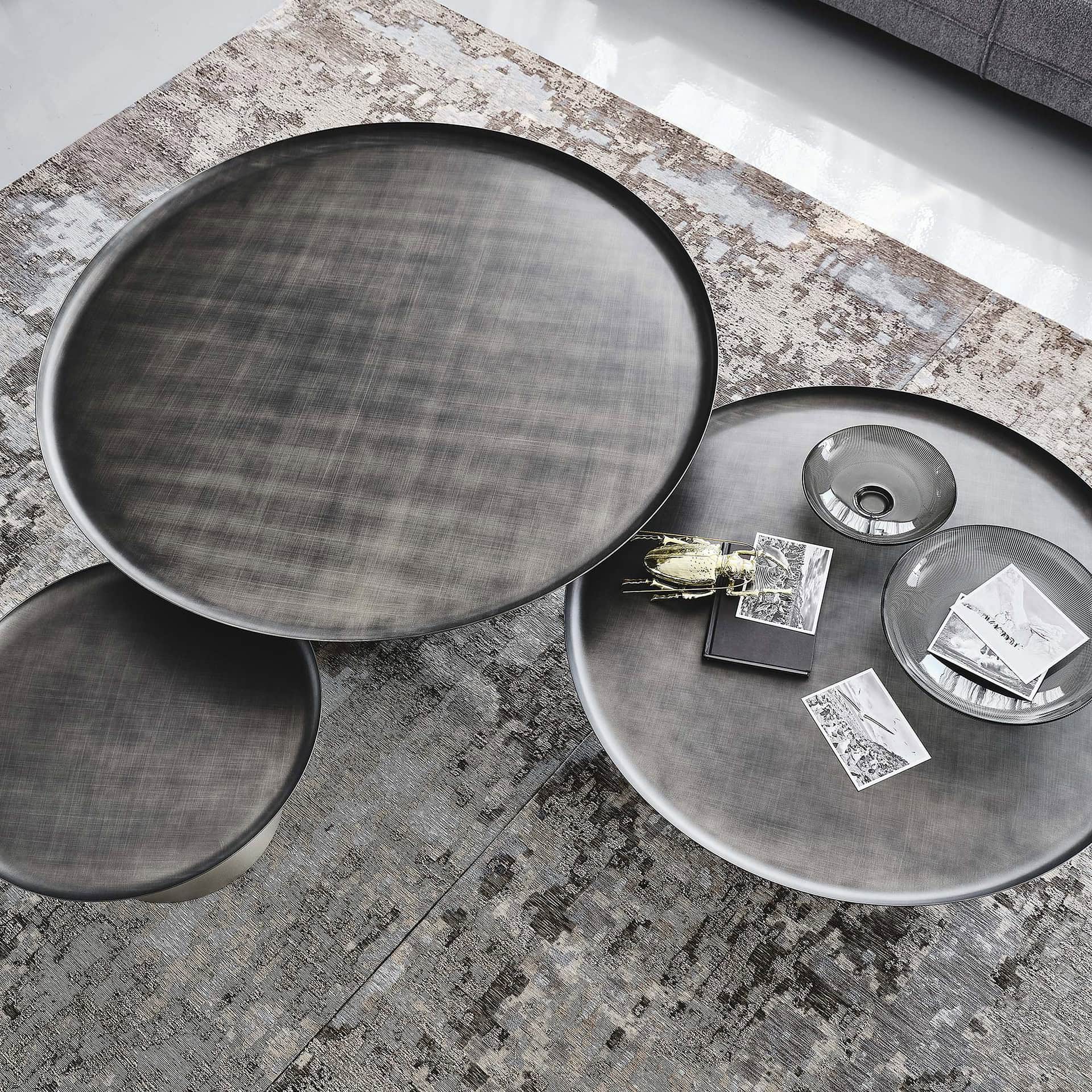 Overhead view of Amerigo Round Coffee Tables with smoked mirrored glass tops and decorative accents.