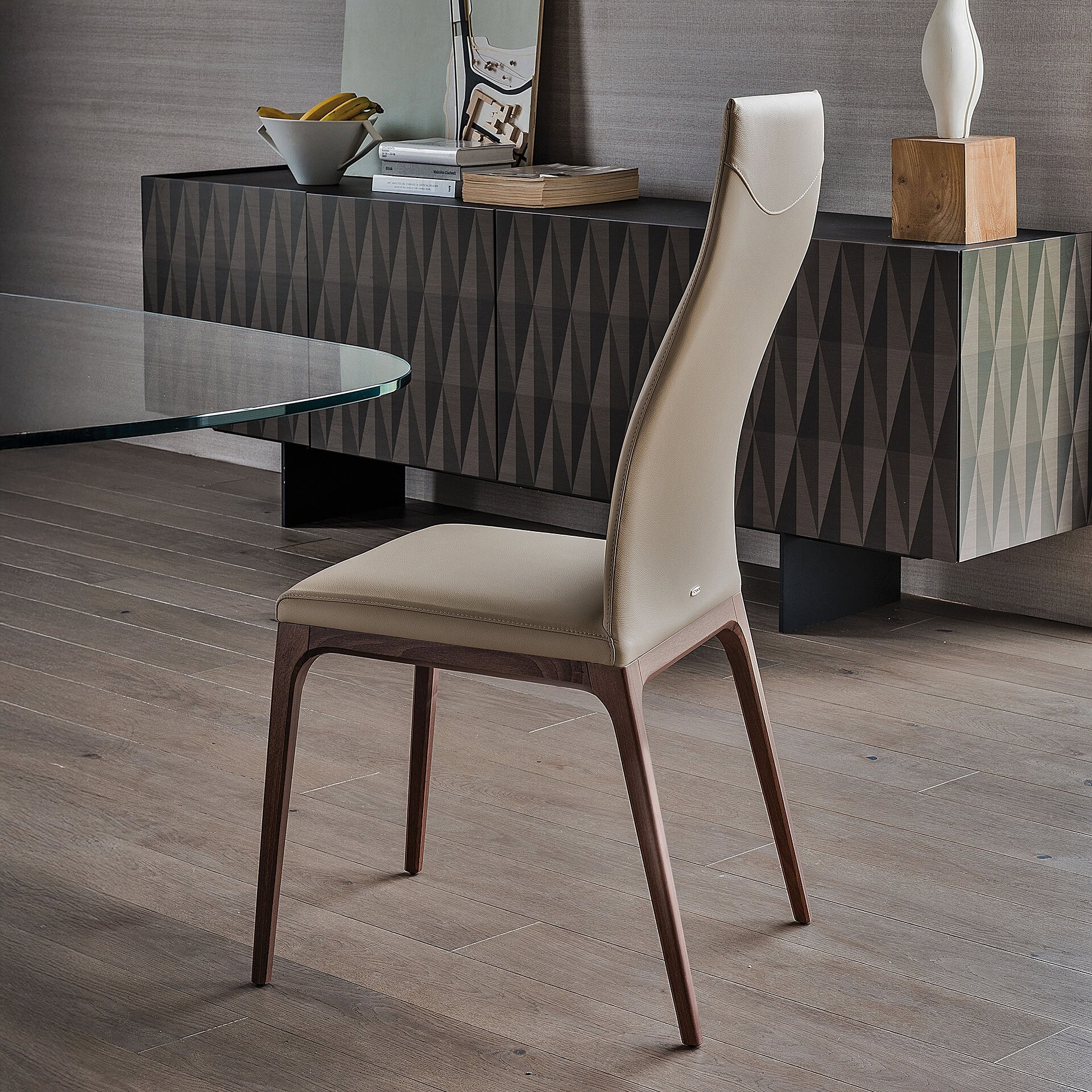 Arcadia High Back Dining Chair in soft leather with natural wood legs, styled in a dining setting.