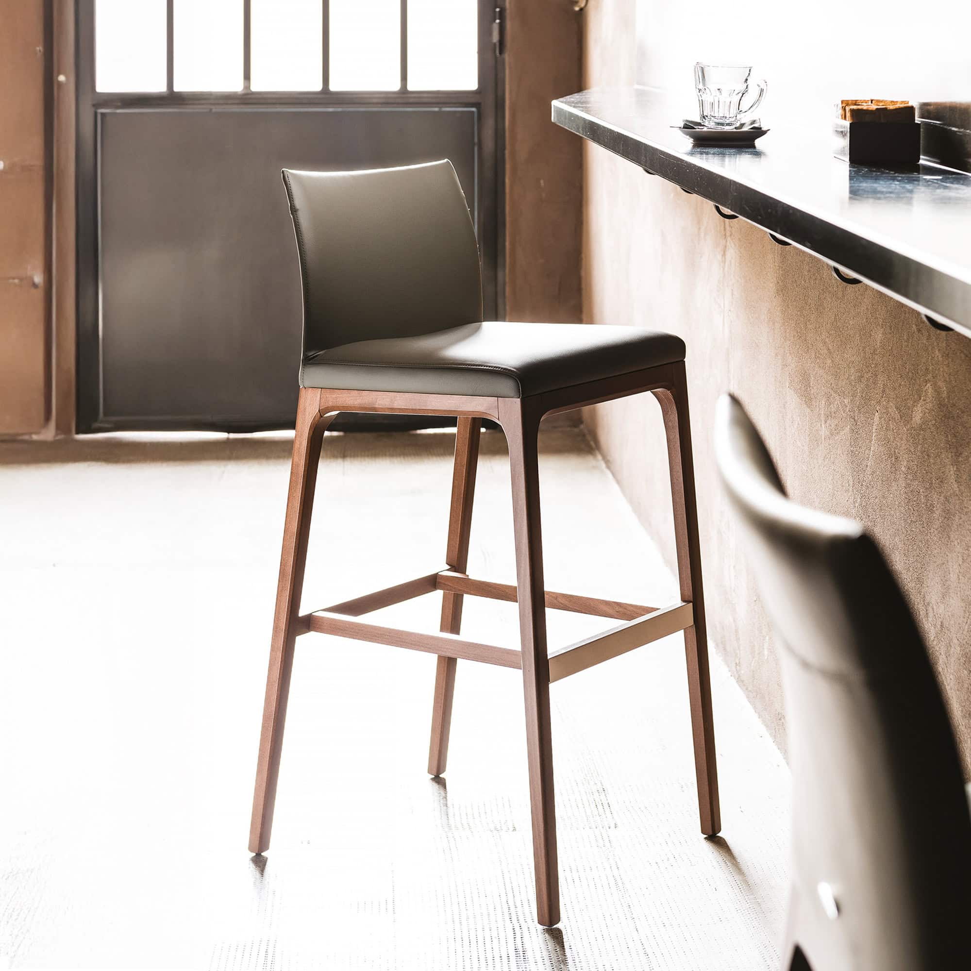 Arcadia Stool with upholstered seat at a modern bar counter.
