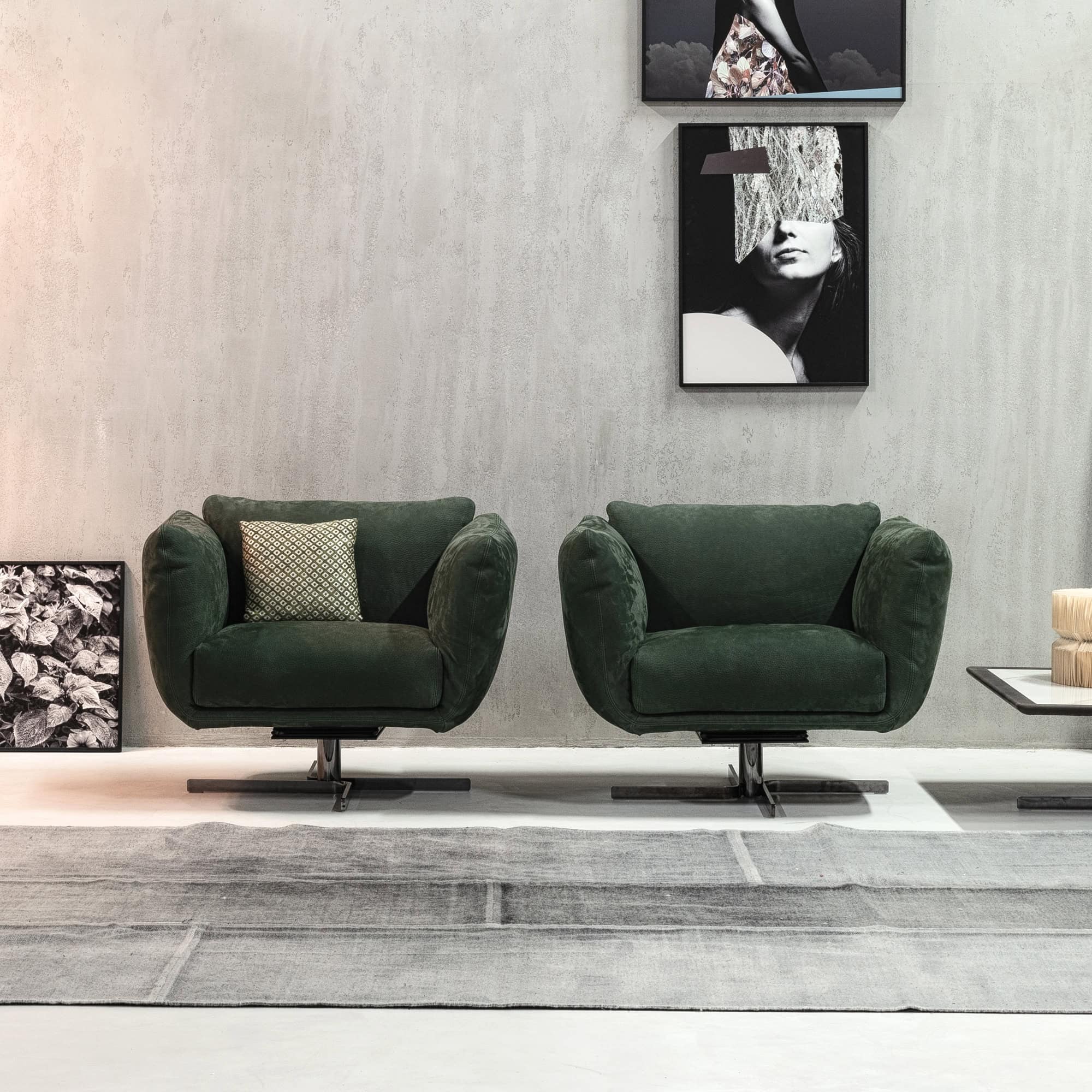 Amélie Swivel Armchairs in green leather displayed in a modern living room setting with clean lines and minimal décor.