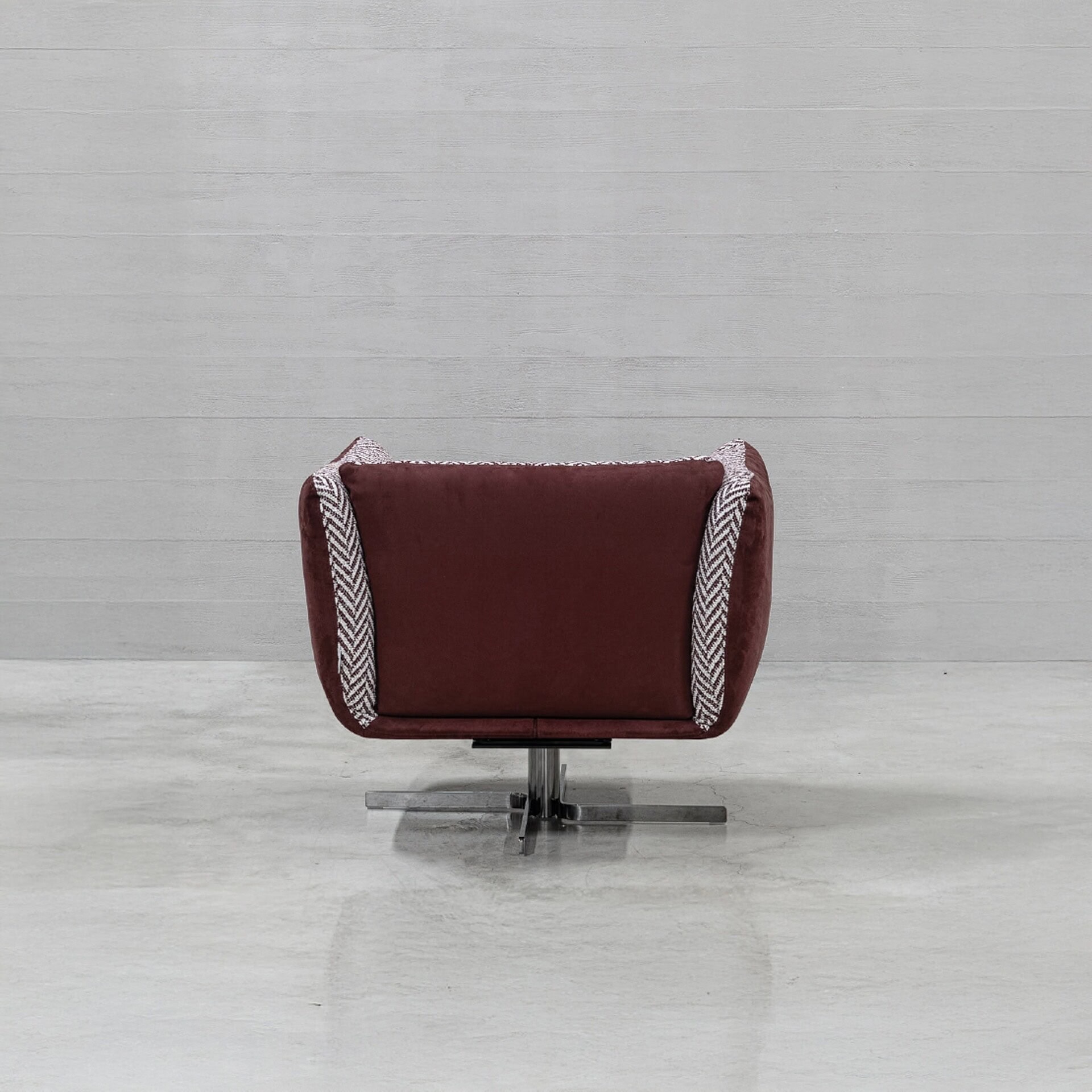Luxurious burgundy swivel chair with modern design, perfect for upscale home or office decor.