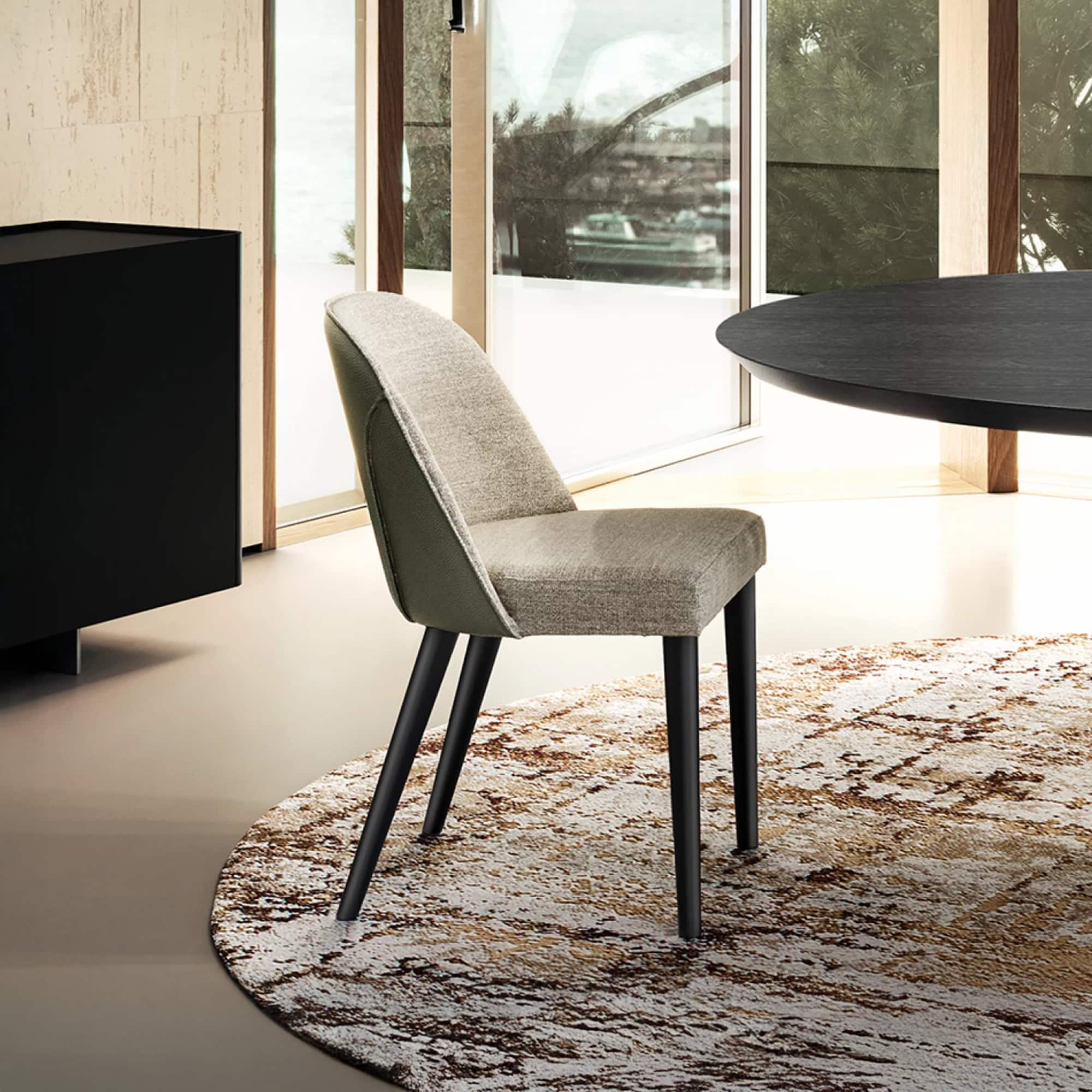 Manta Dining Chair with upholstered seat and back, shown in a modern dining setting.
