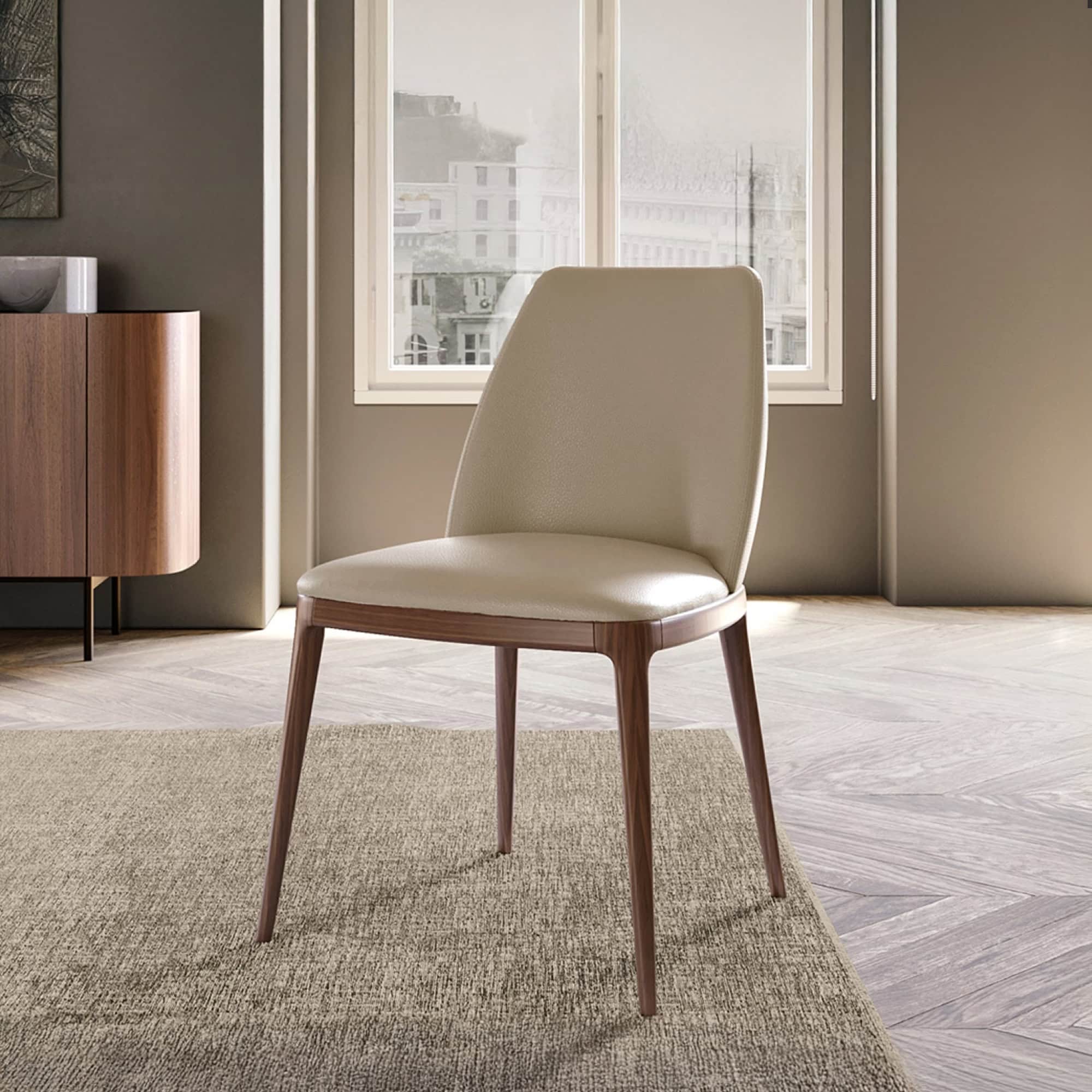 Max Dining Chair with arms in beige leather shown in a modern interior setting.